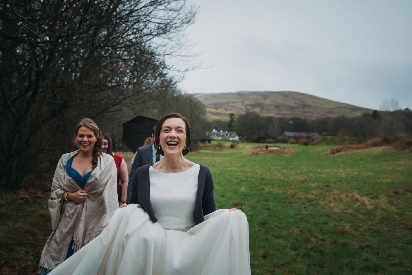Laura can't stop laughing at how bad the weather is, but got married out in it anyway!