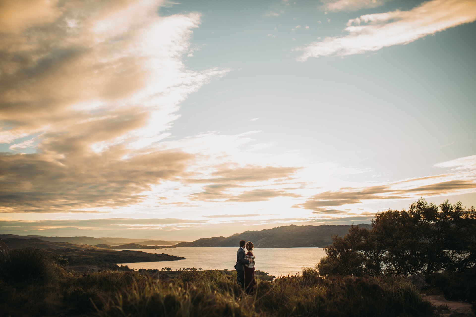 eloping to scotland romantic elopement photography Scotland newlyweds and epic golden view over Torridon