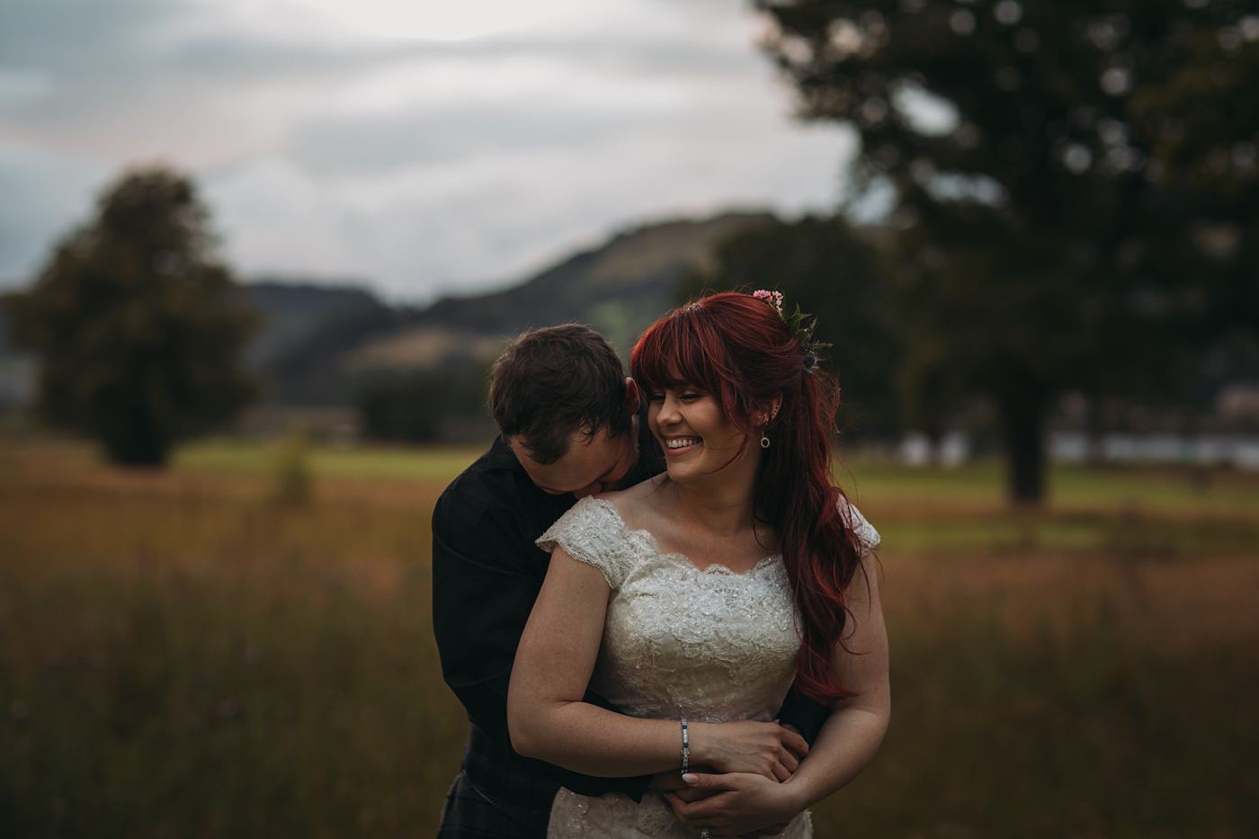 A couple embrace in the evening light at this Mar Hall wedding
