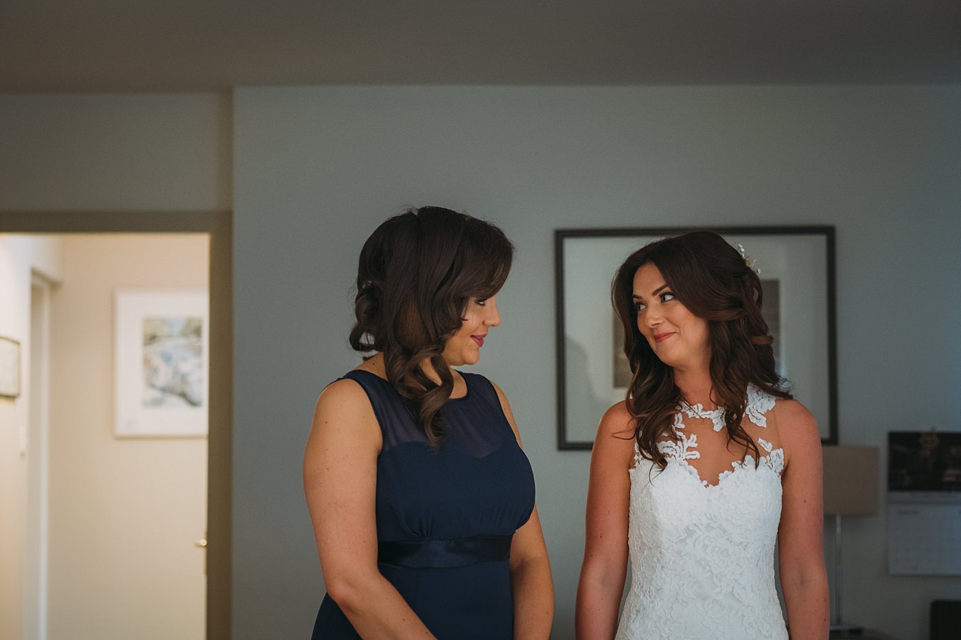 Moment between bride and bridesmaid during a Christmas wedding at Glen Tanar