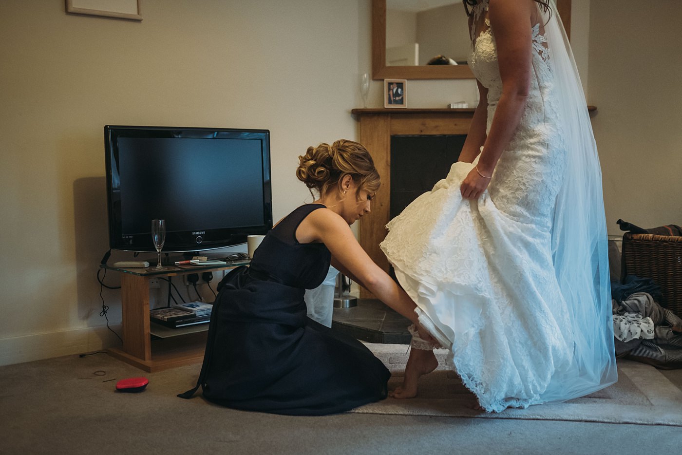 bridesmaid helps bride at her Christmas wedding at Glen Tanar