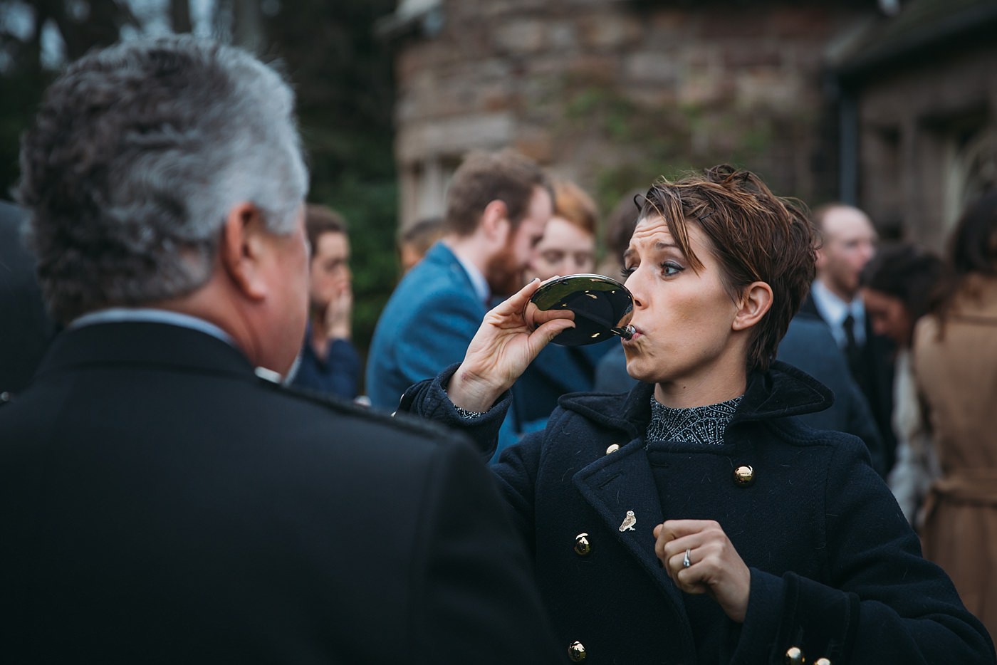 guest drinks from a hip flask at a Christmas wedding at Glen Tanar