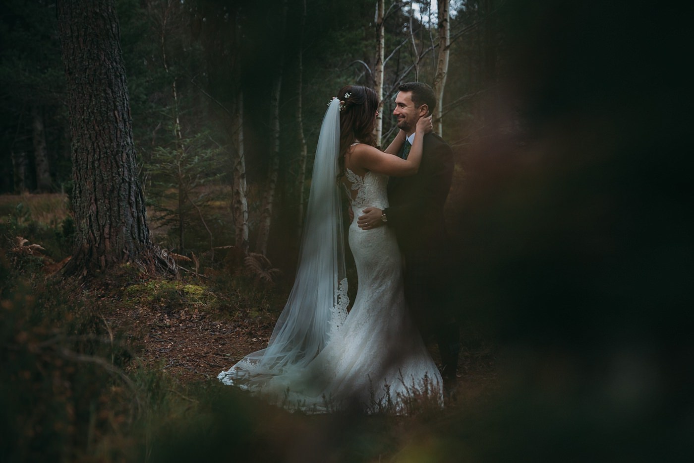 bride warms her hands on her husband at this Christmas wedding at Glen Tanar