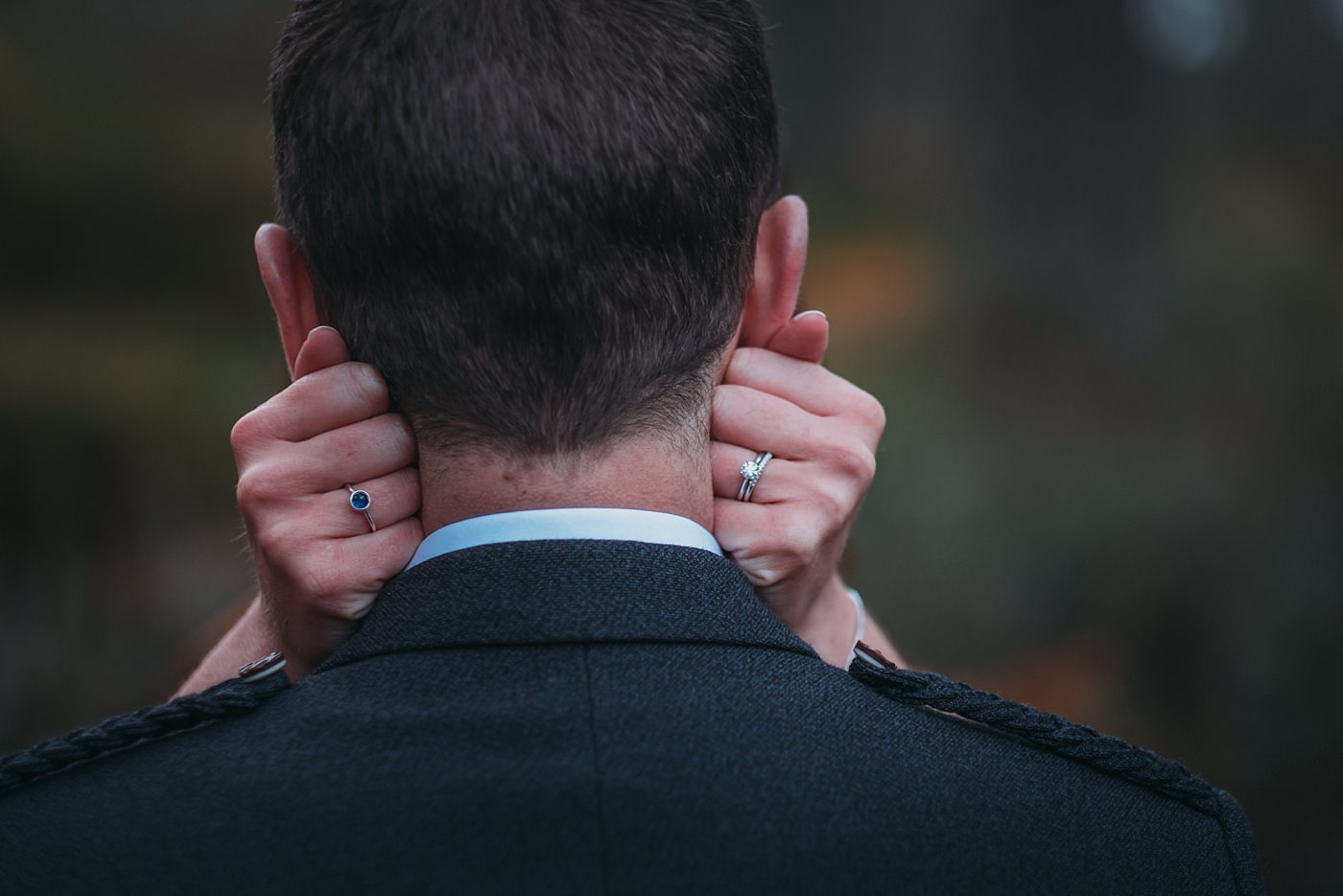 bride has cold hands at her Christmas wedding at Glen Tanar and warms them on the grooms neck