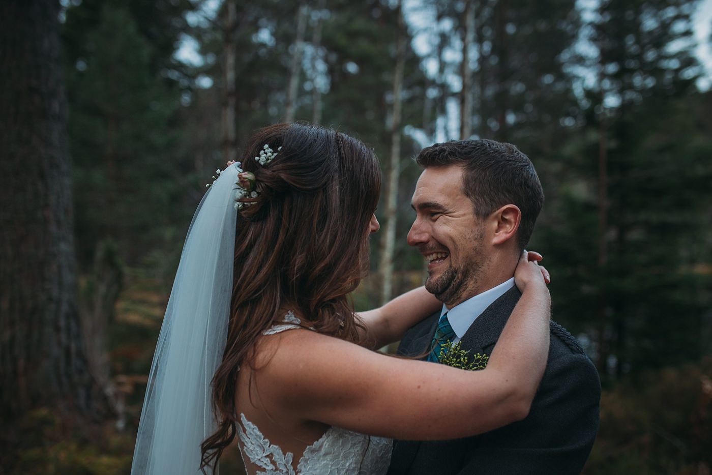 newlyweds laughing together at their Christmas wedding at Glen Tanar