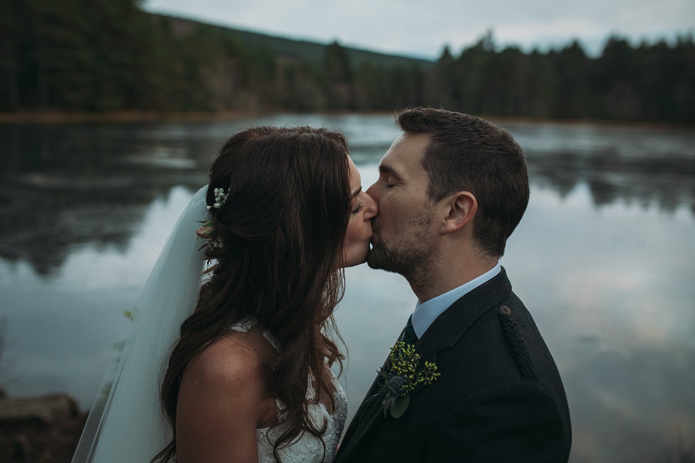 newlyweds kiss at their Christmas wedding at Glen Tanar