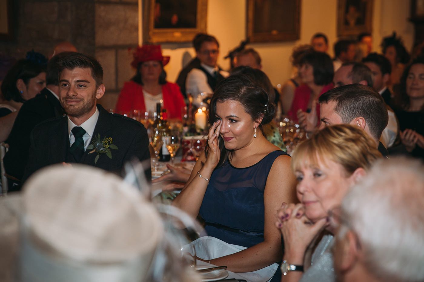 bridesmaid cries during speeches at a Christmas wedding at Glen Tanar