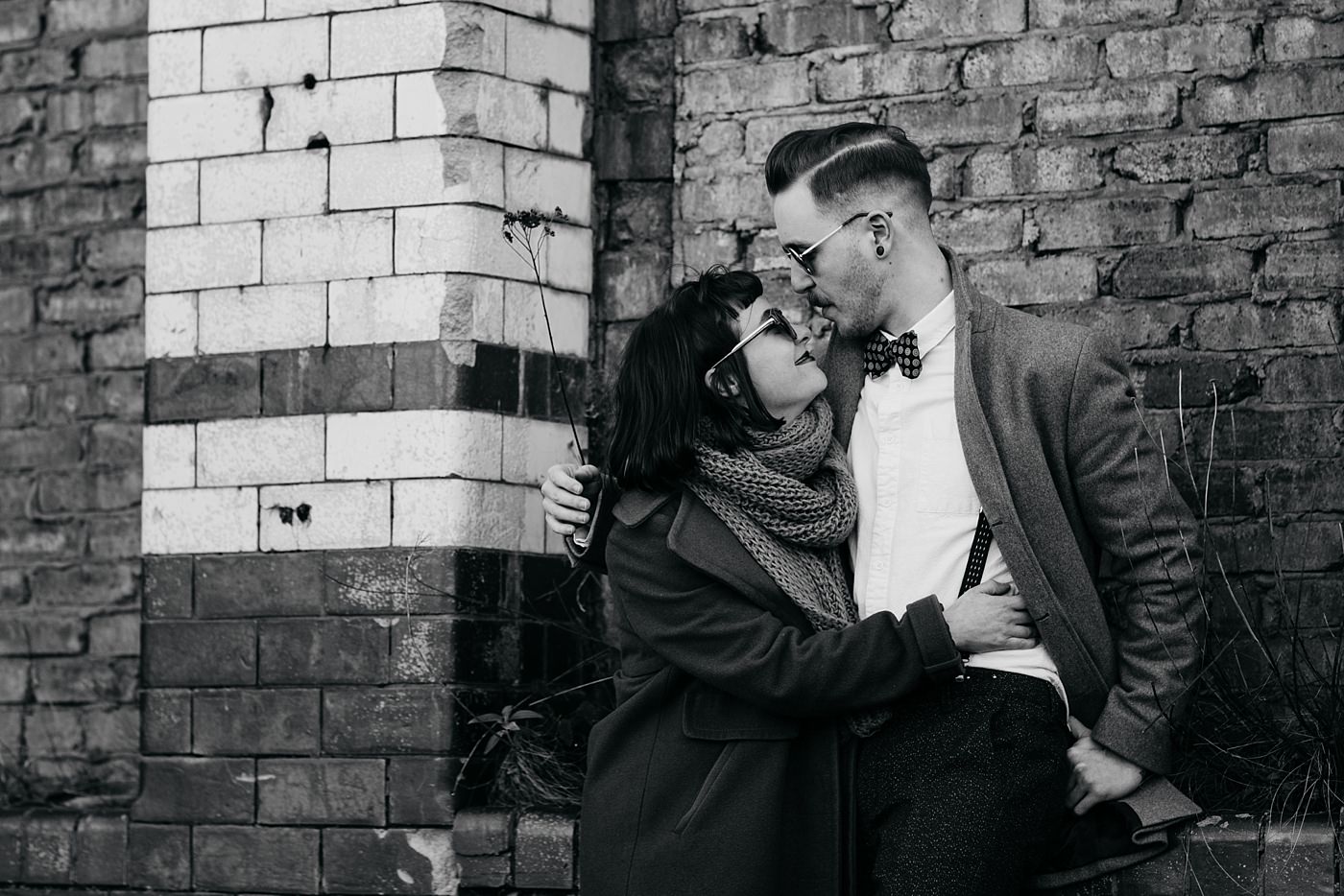 A black and white photo of Bygone Photobooth Company Owners Joe & Steph near the Glue Factory in Glasgow