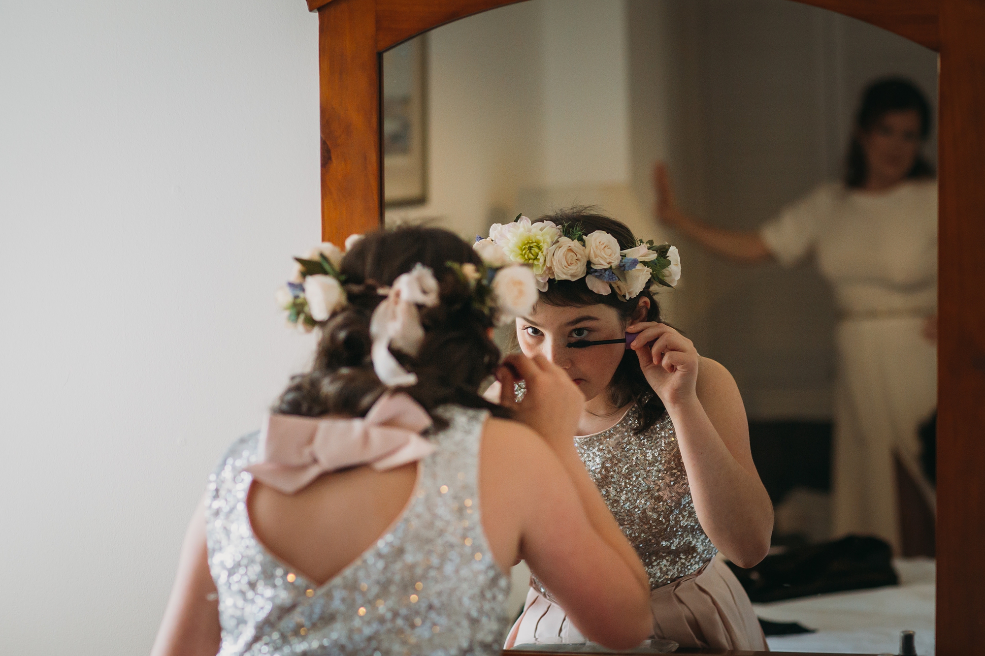 best wedding photographs of the brides daughter putting makeup on as her Mum watches on