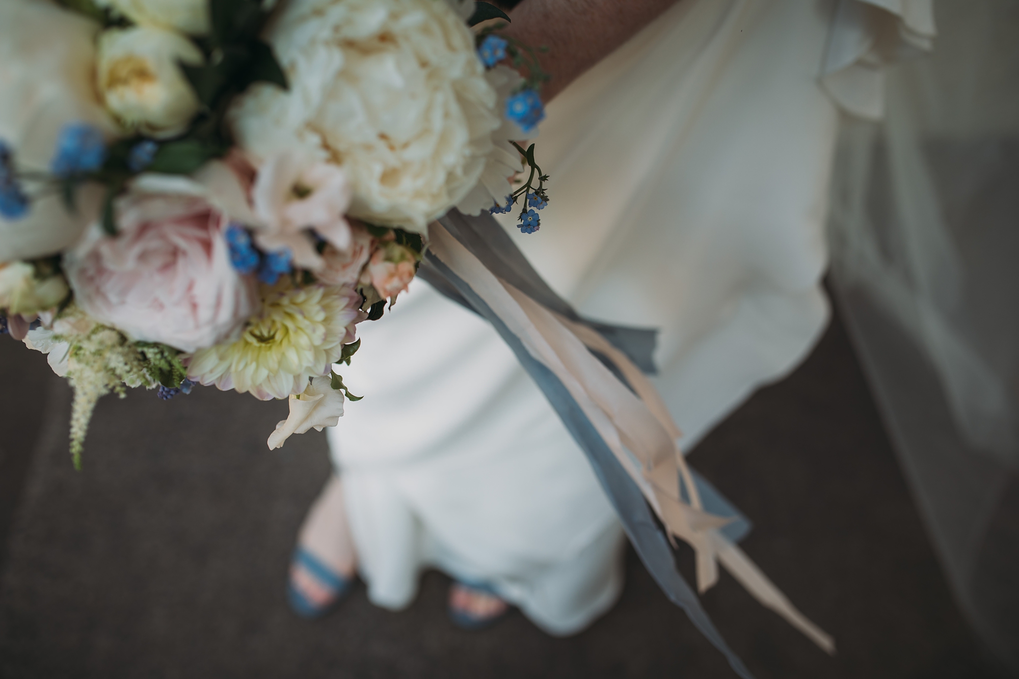 best wedding photographs of a brides bouquet blowing in the wind