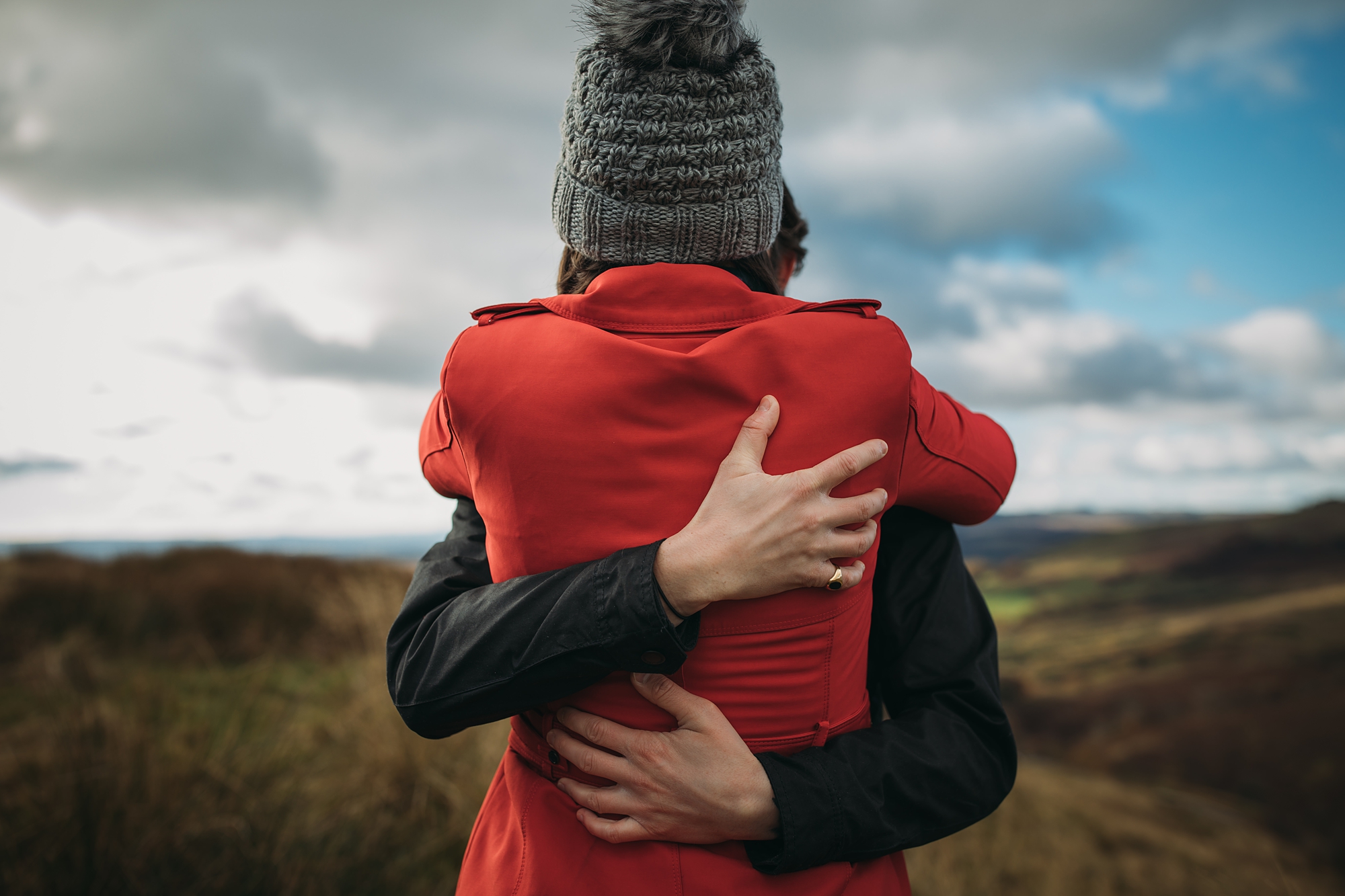 best wedding photographs of newlyweds hugging on a hill