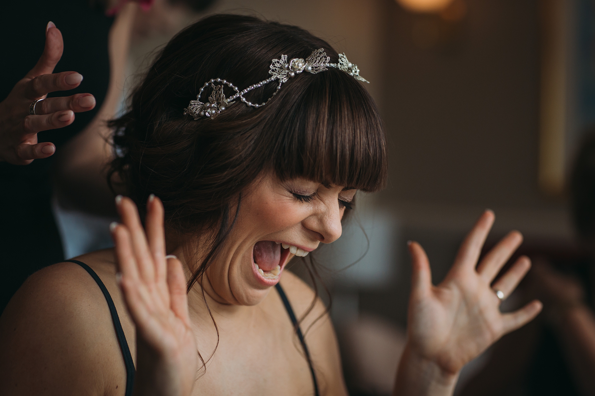 best wedding photographs of a bride getting excited about her head piece