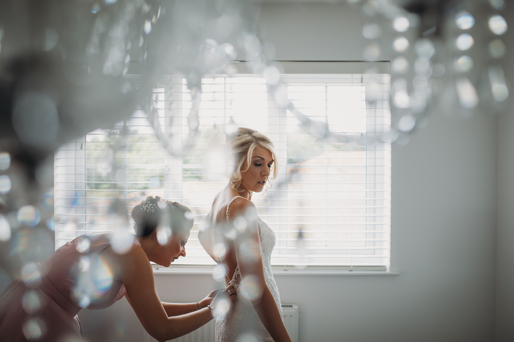 best wedding photographs of a bride putting her dress on