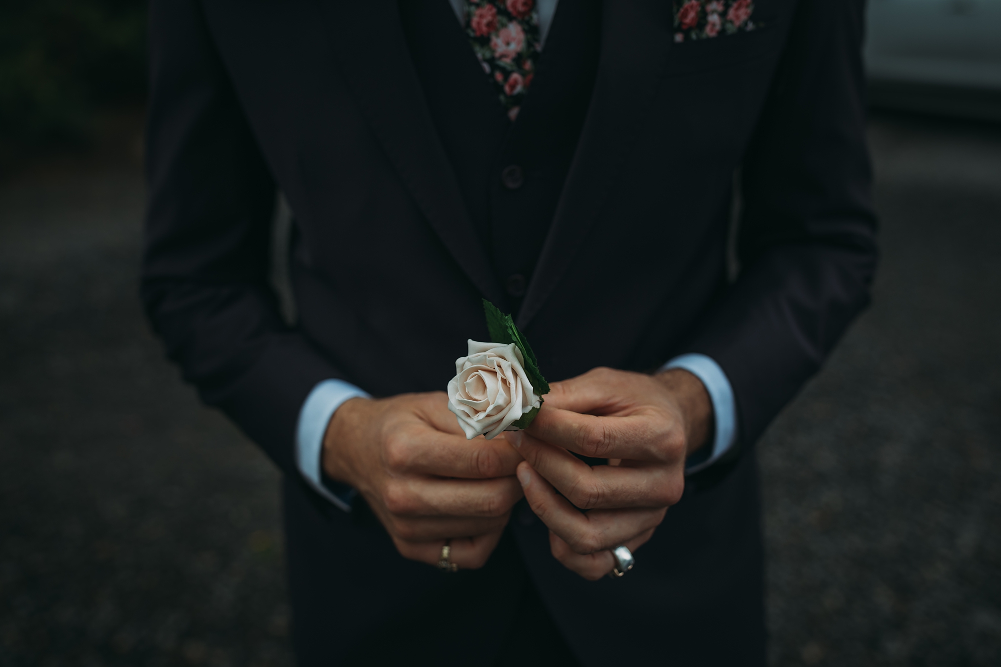 best wedding photographs, groom holds a flower