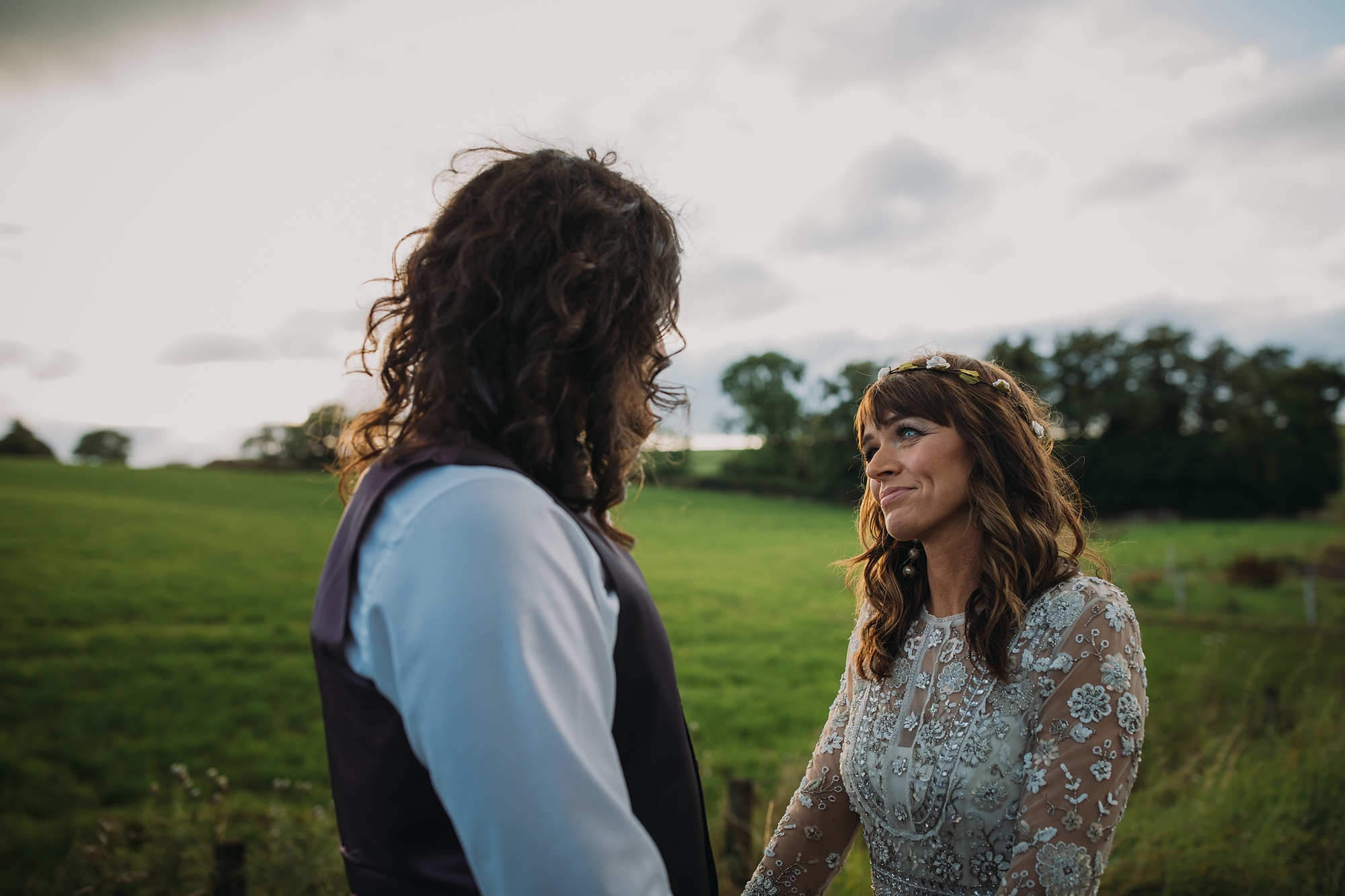 Newlyweds look at each other in the evening light - best wedding photographs Scotland