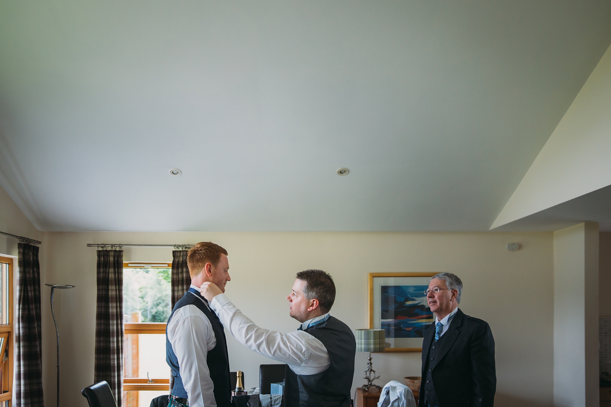 best wedding photographs of the groom getting ready with his brother and dad