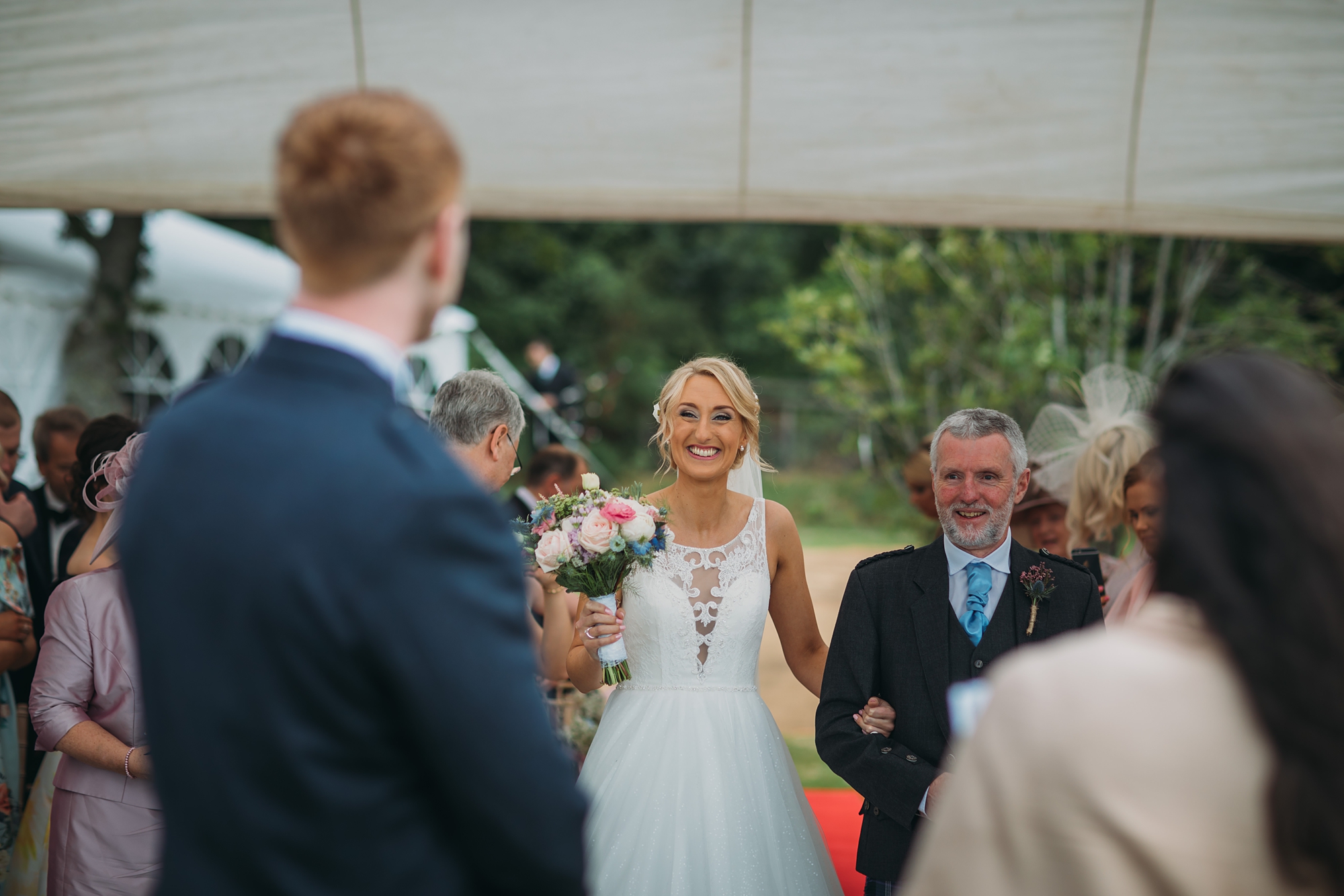 best wedding photographs of bride arriving to her outdoor ceremony at loch lomond