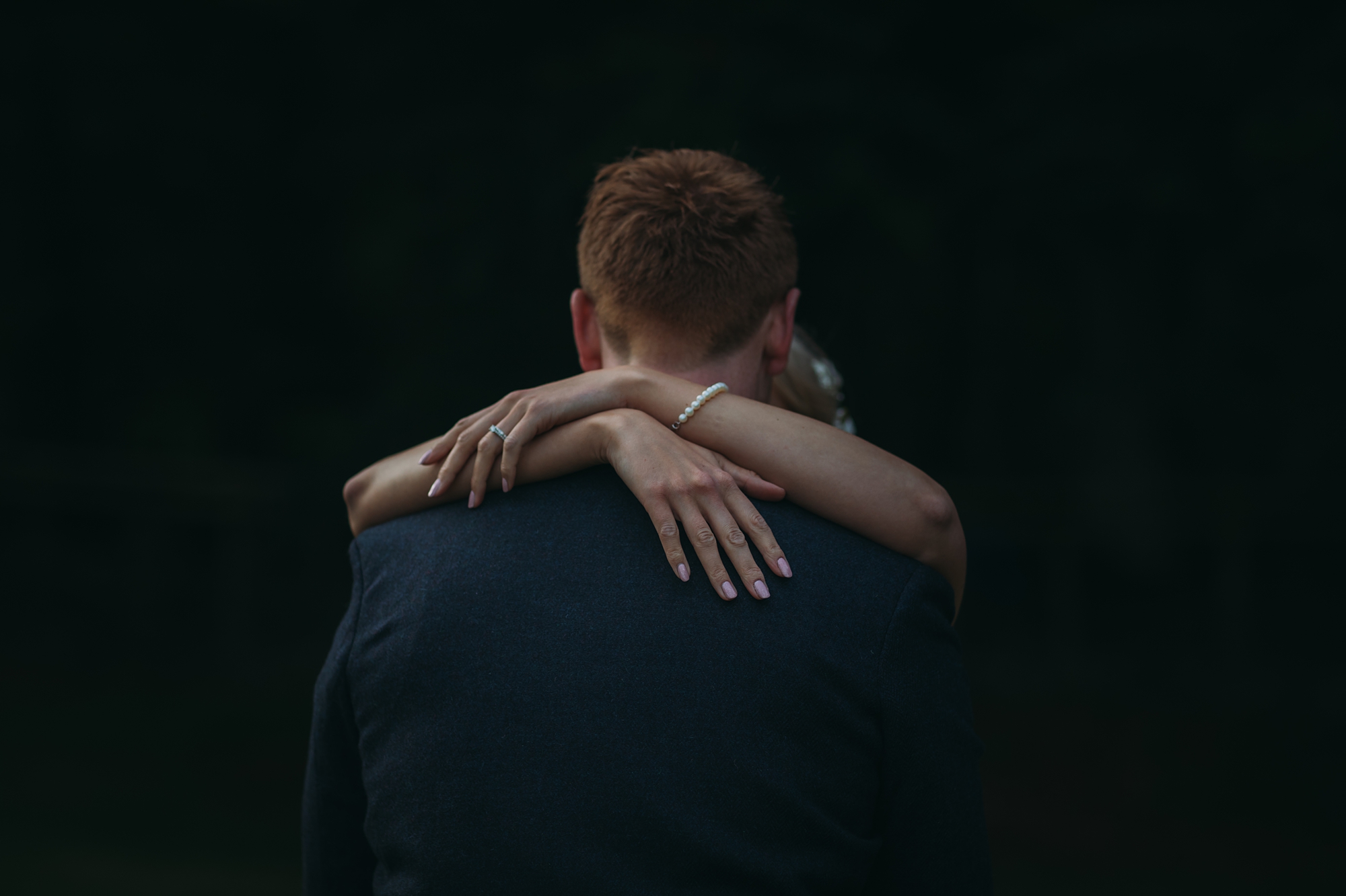 best wedding photographs brides hands gently round her grooms shoulders