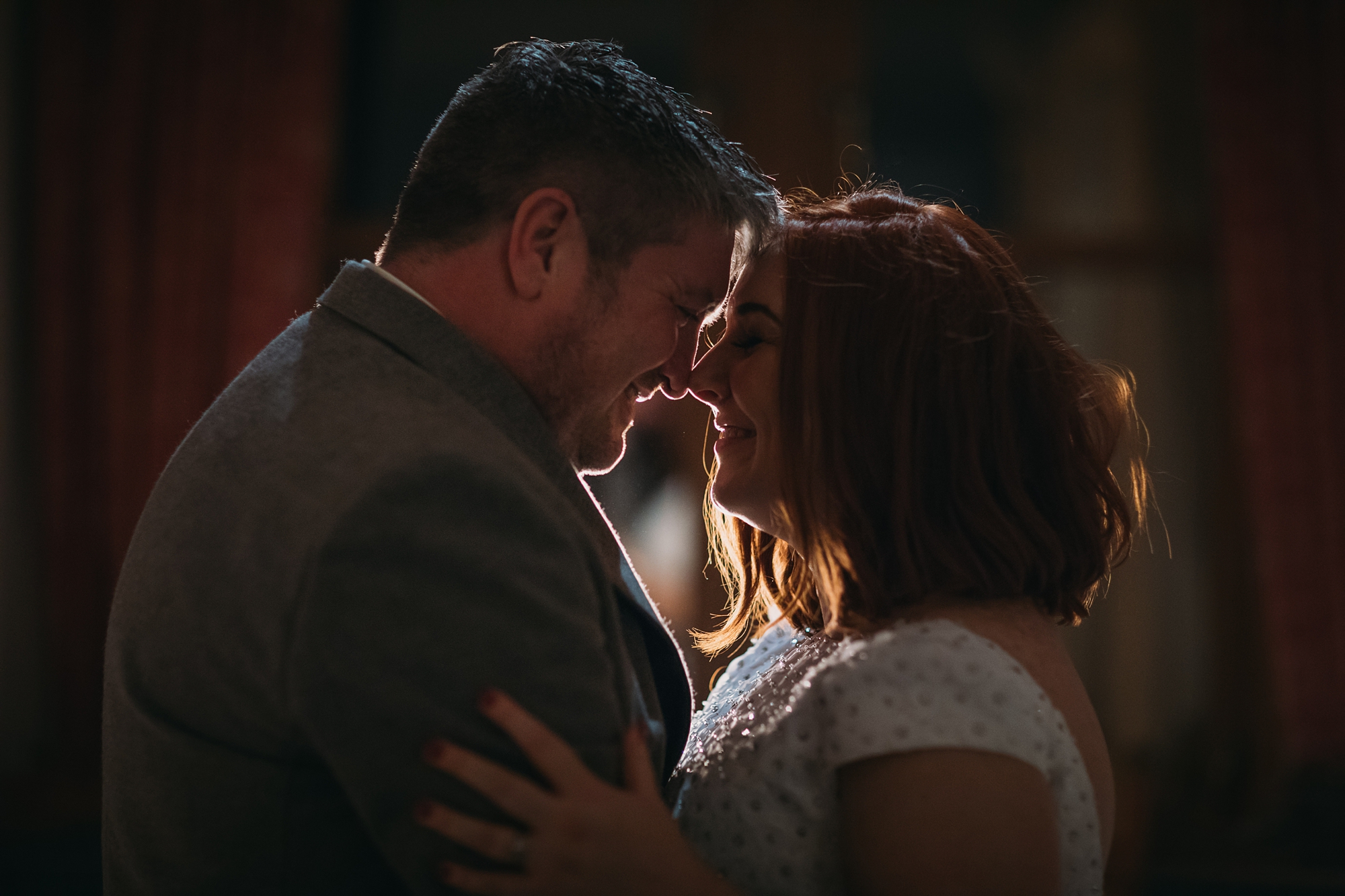best wedding photographs - newlyweds embrace in low light