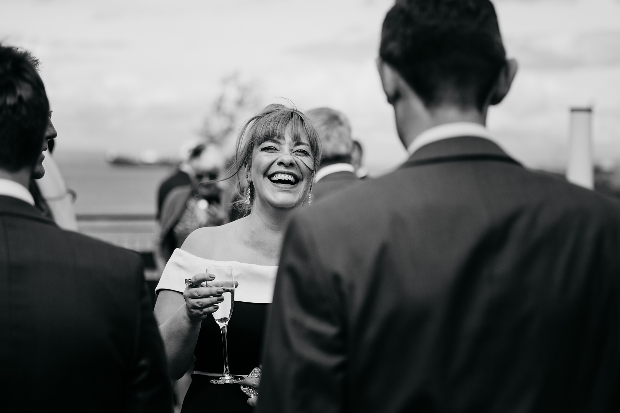 our best wedding photographs - a guest laughing as her hair blows in the win on arran