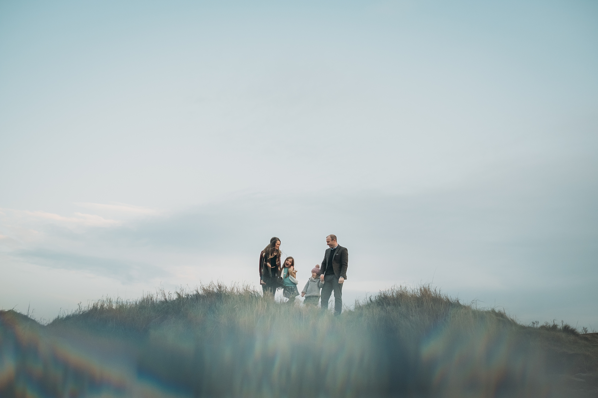 a family on top of a hill, best wedding photographs