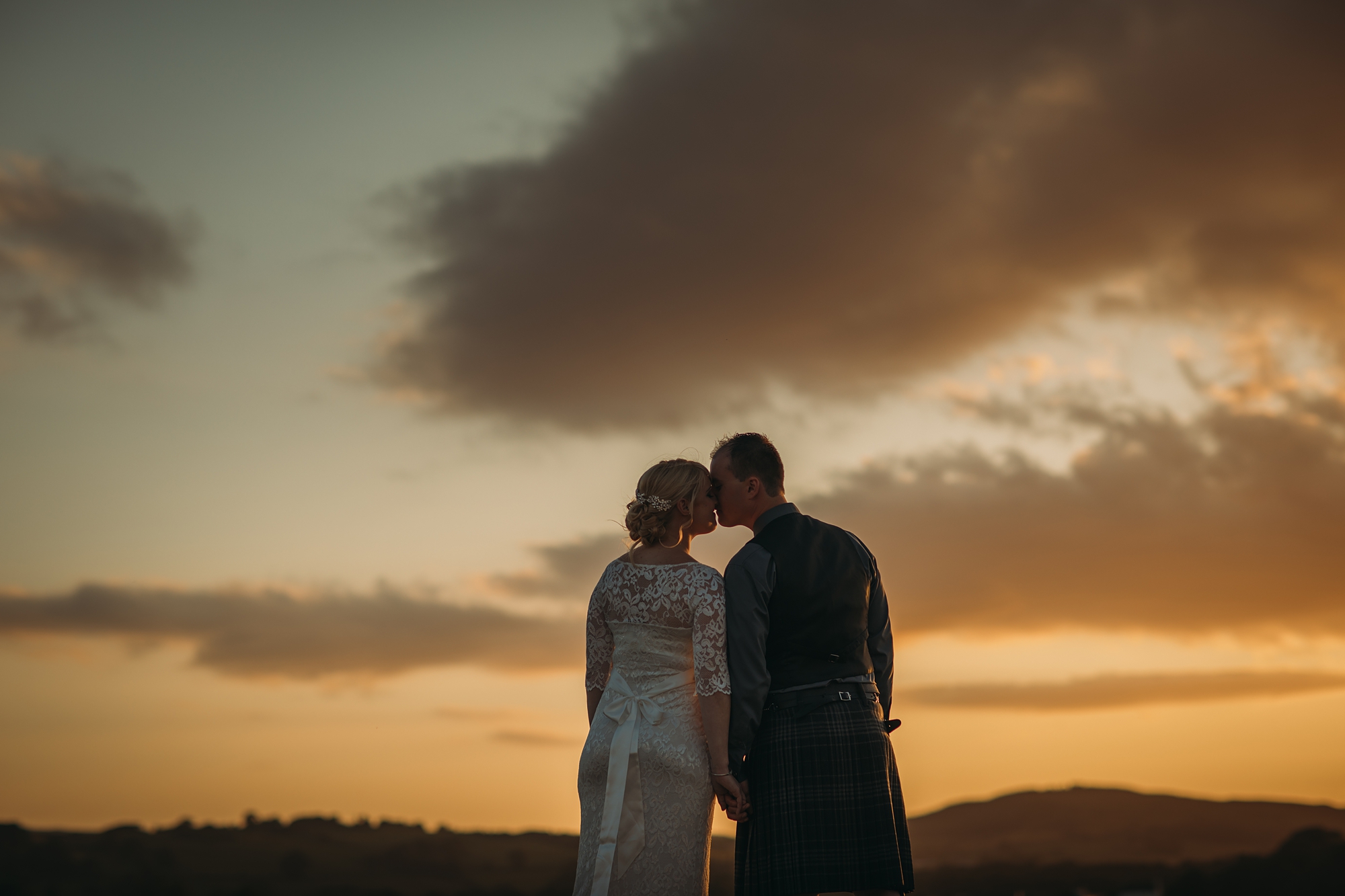 a couple embrace at sunset in Glencaple - best wedding photographs