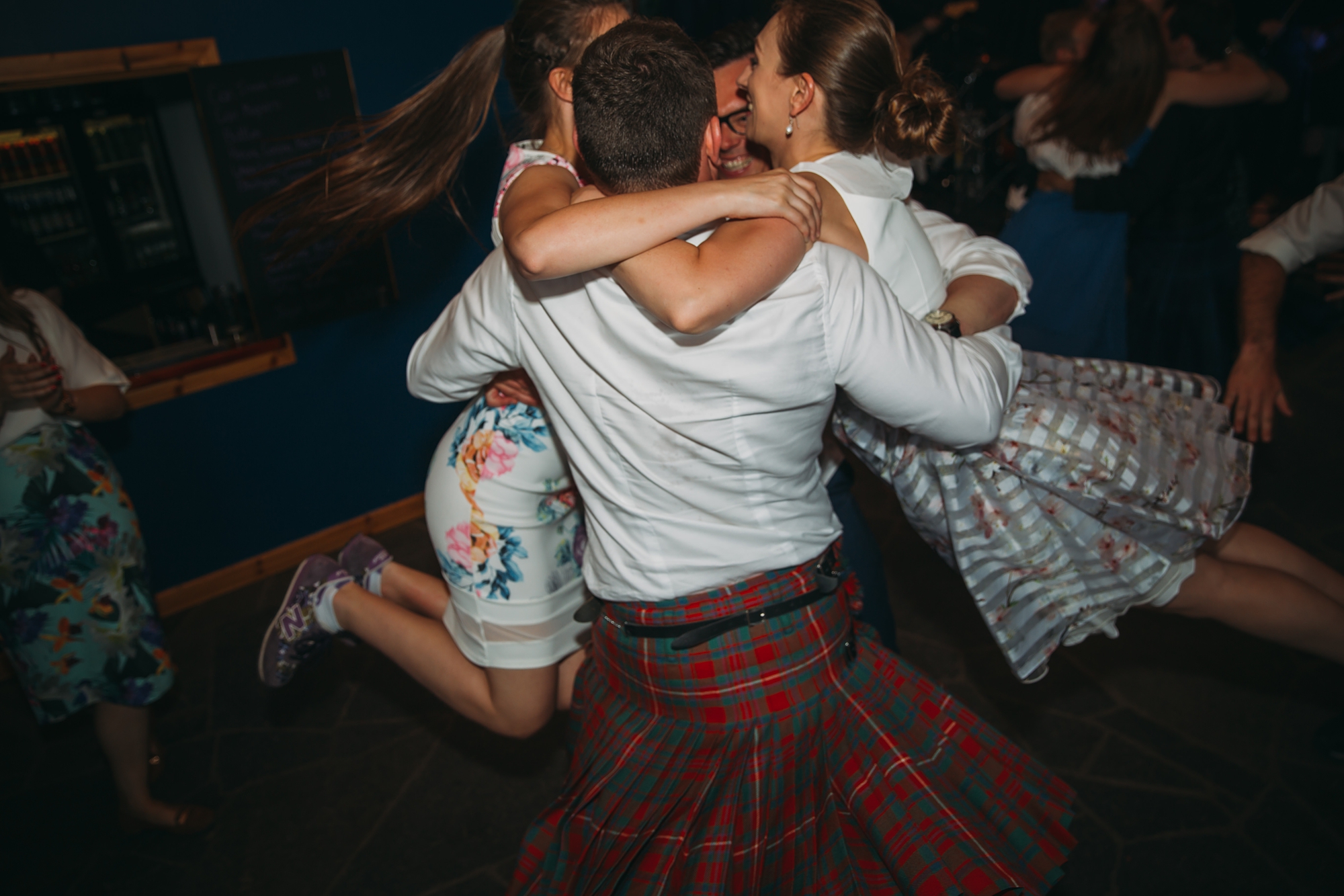 Girls lifted off the ground during evening reception for our best wedding photographs