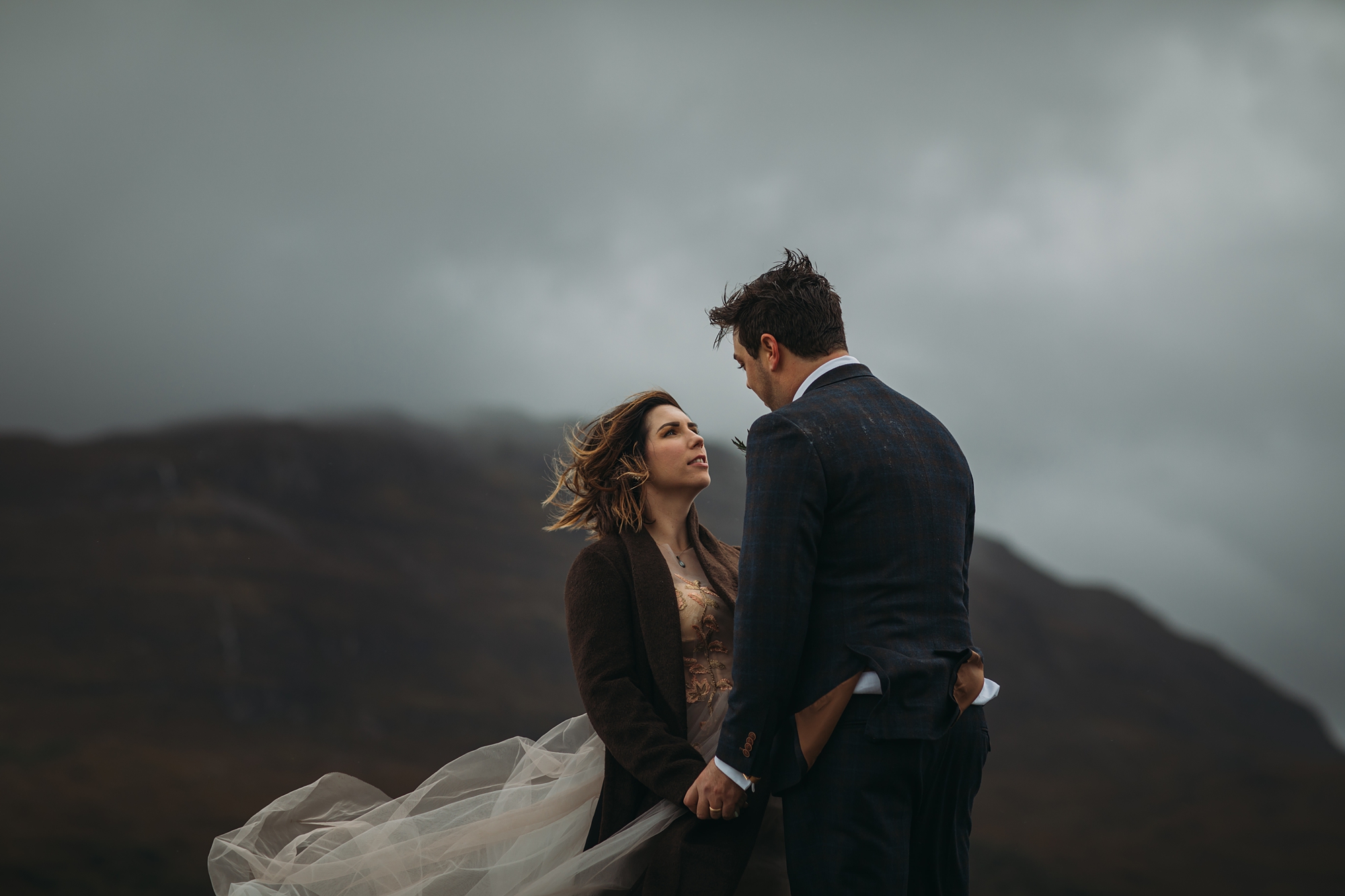best wedding photographs - A couple gaze at each other in the epic Scottish landscape
