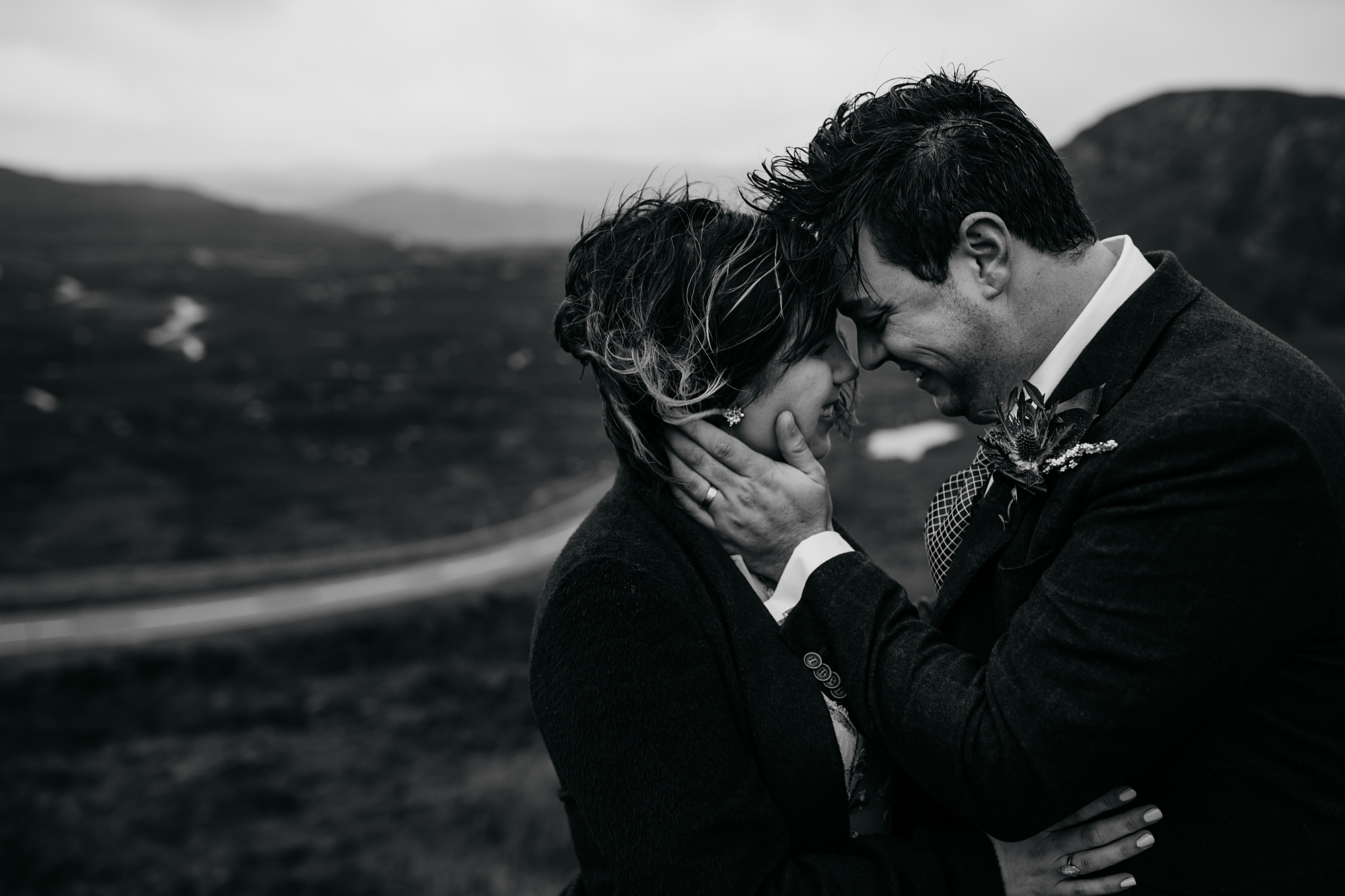 A couple embrace tightly in the rain - best wedding photographs