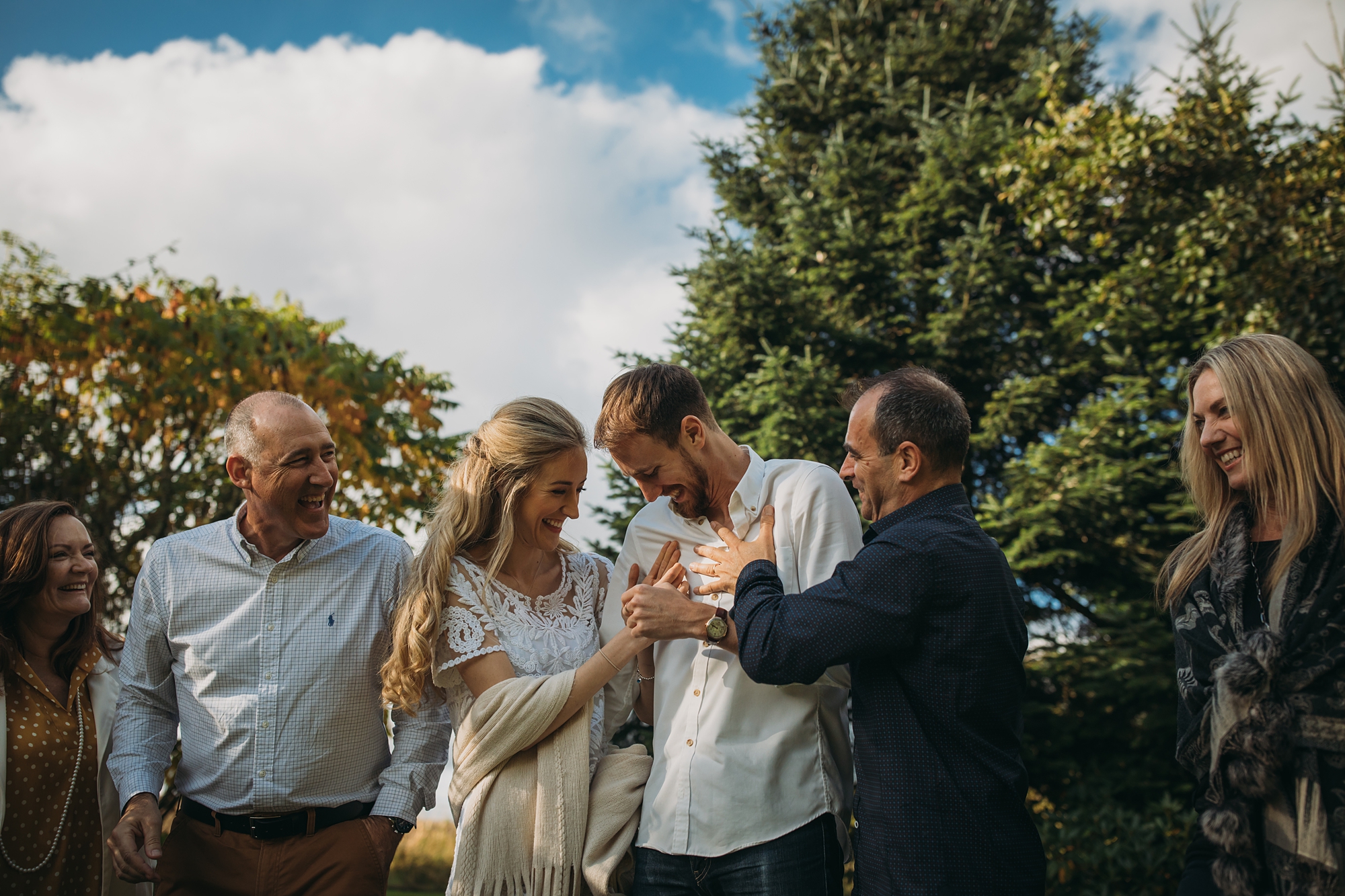 A family joke around with each other, best wedding photographs