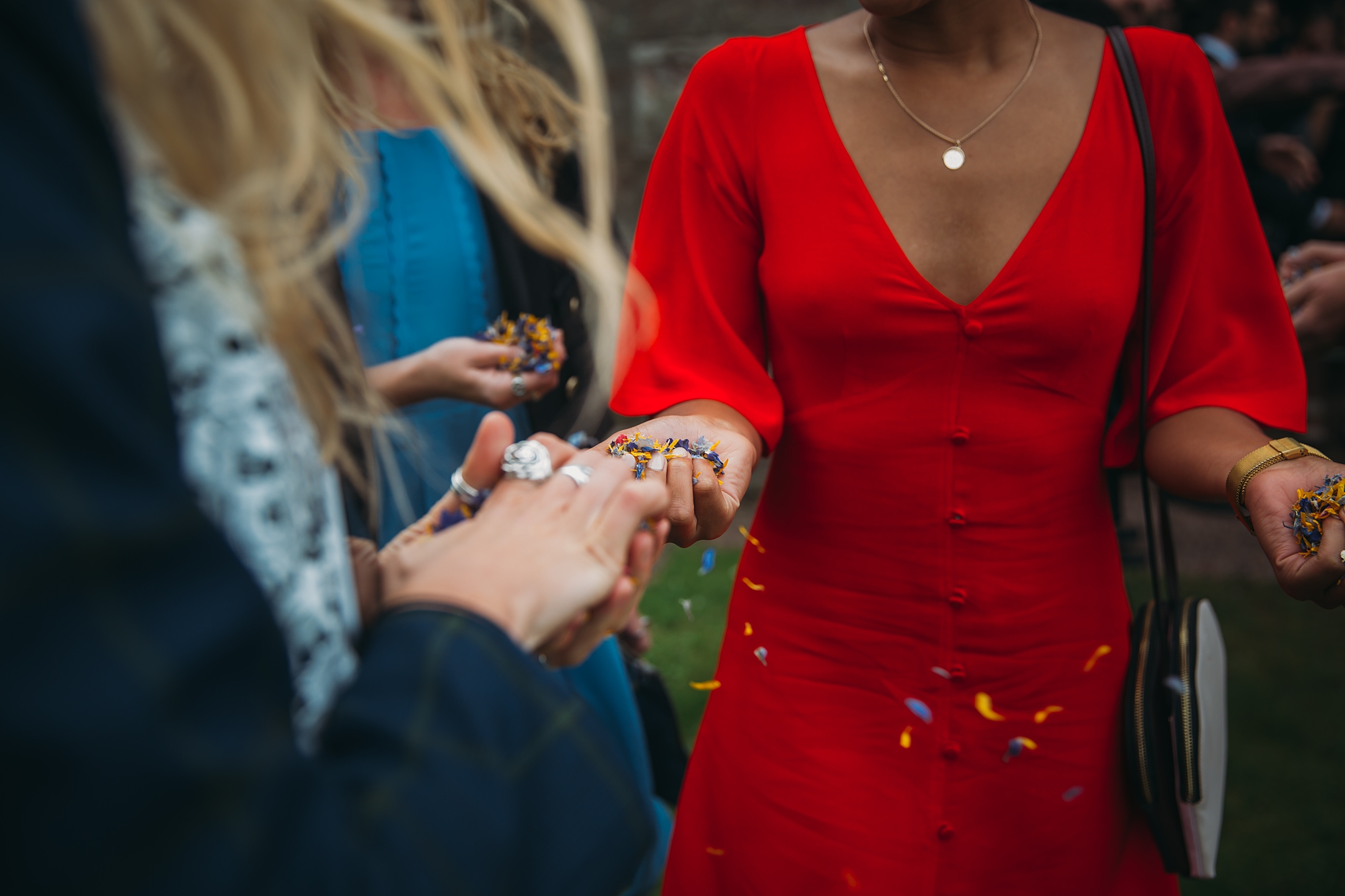 Confetti blowing out a guests hand - best wedding photographs