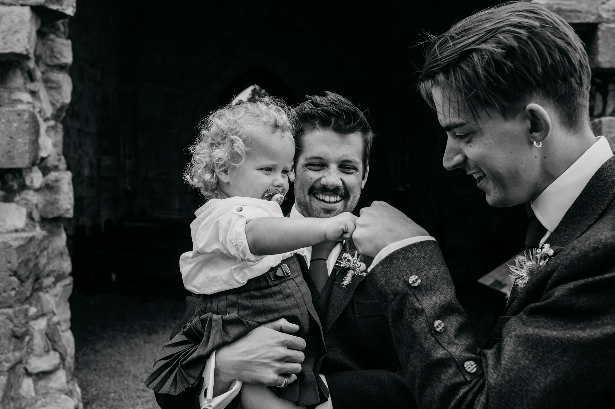 A baby fist bumps the groom in our best wedding photographs blog