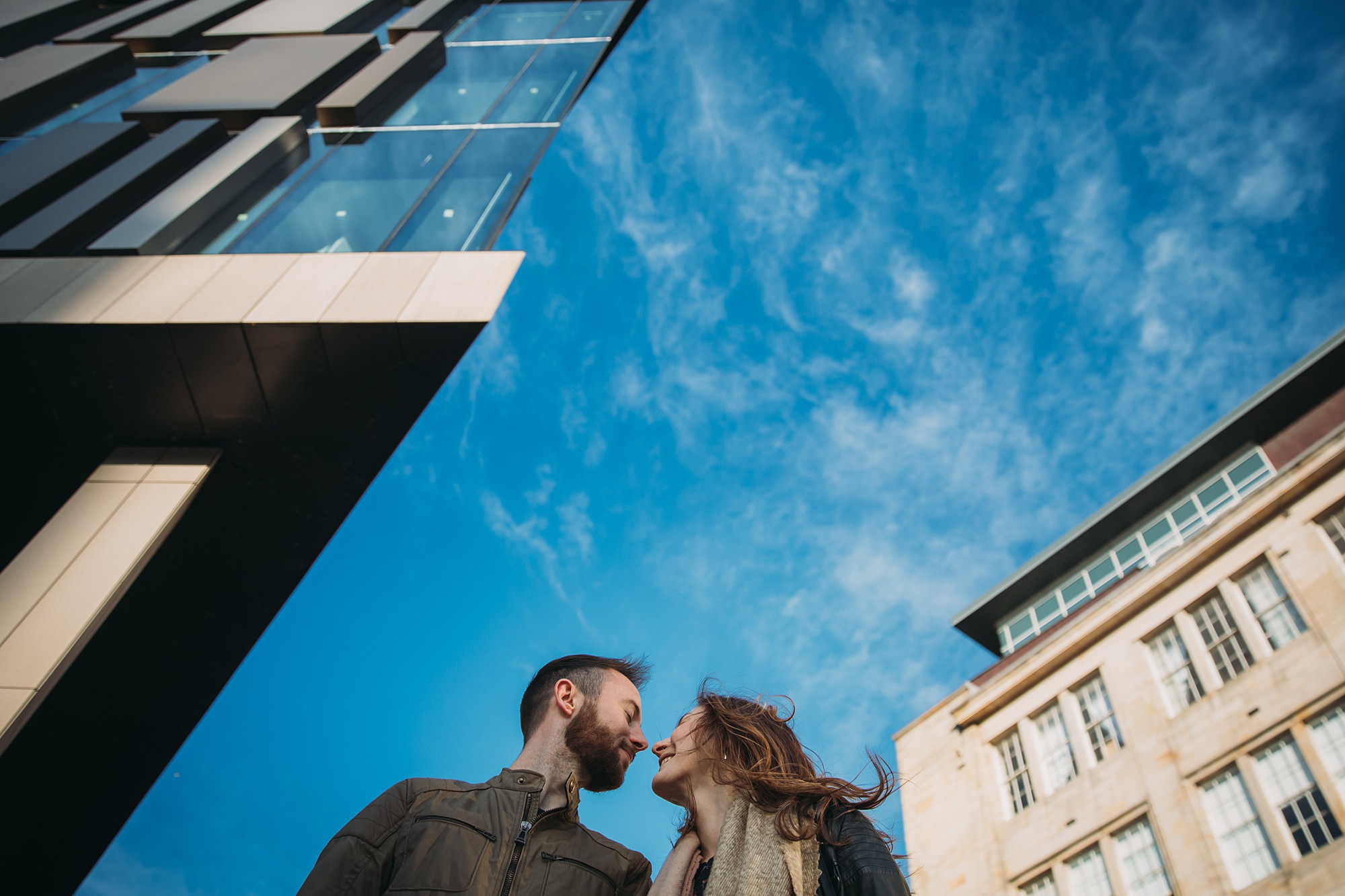 Cool couple and awesome old and new architecture during a Glasgow engagement