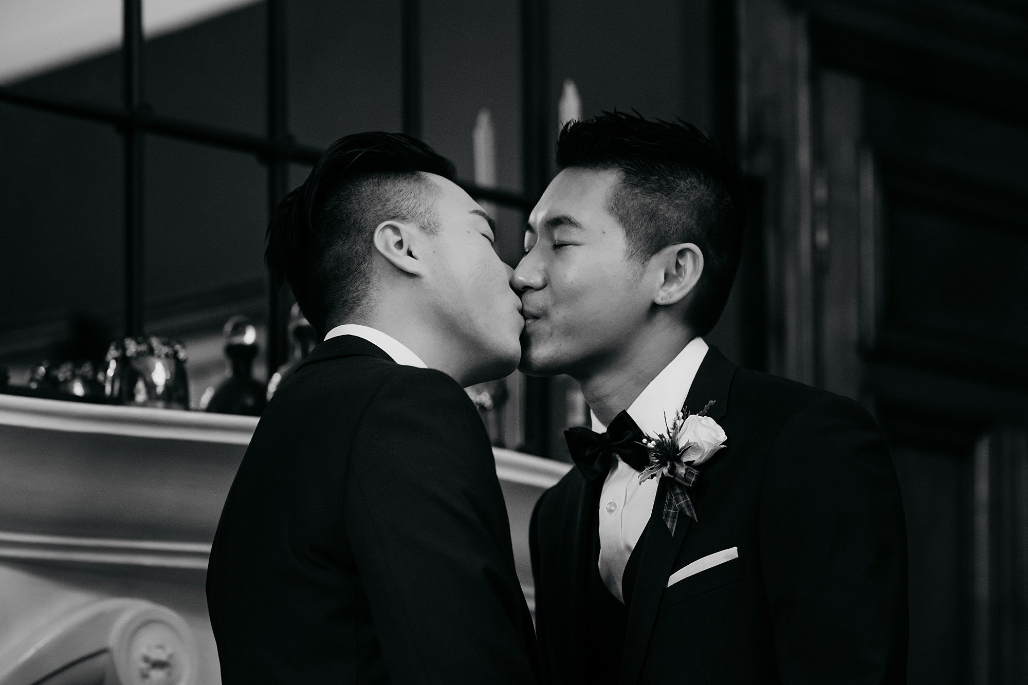 First kiss of two grooms during their Glasgow elopement.