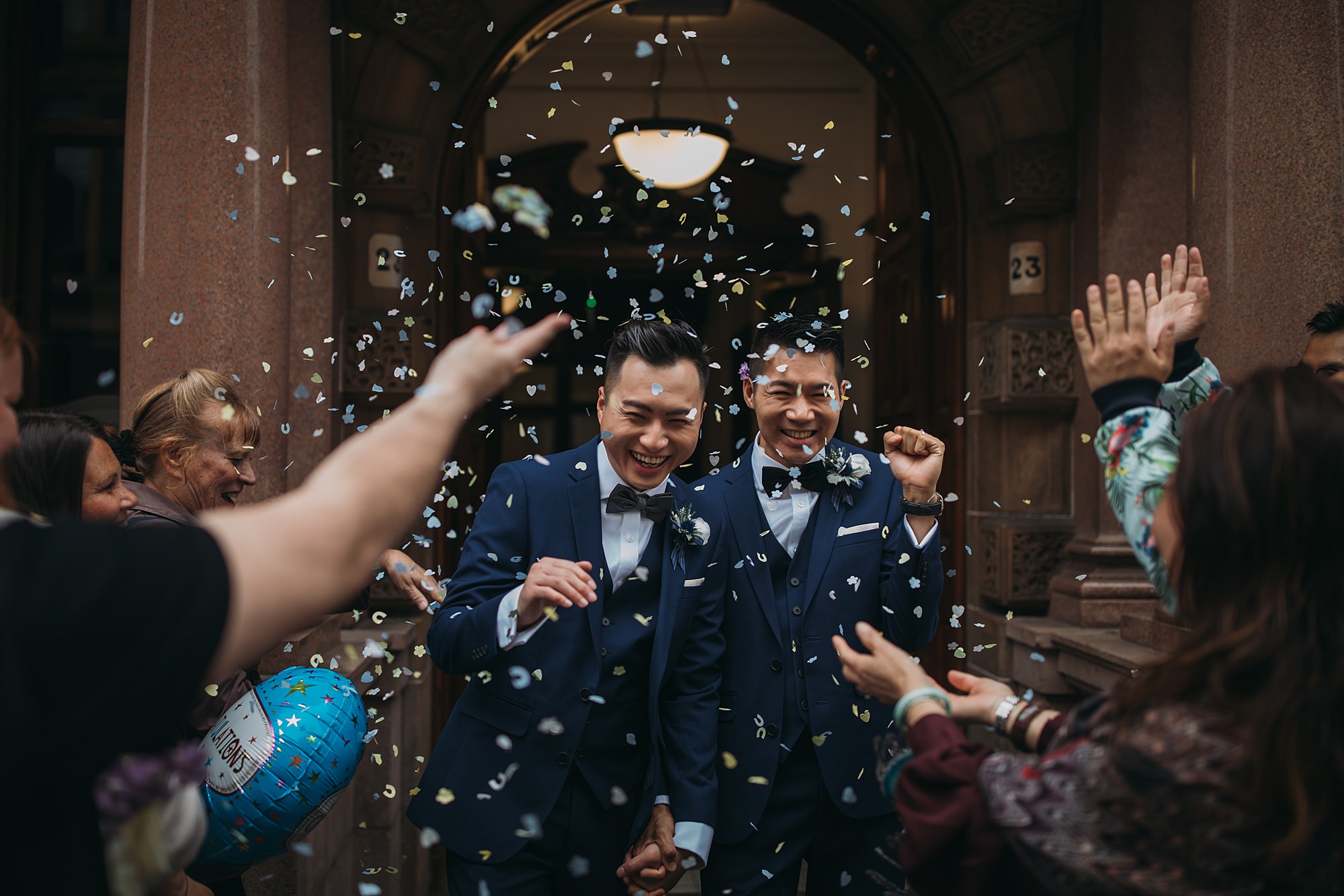 Two grooms leave their Glasgow elopement. ceremony, guests throw confetti at them!