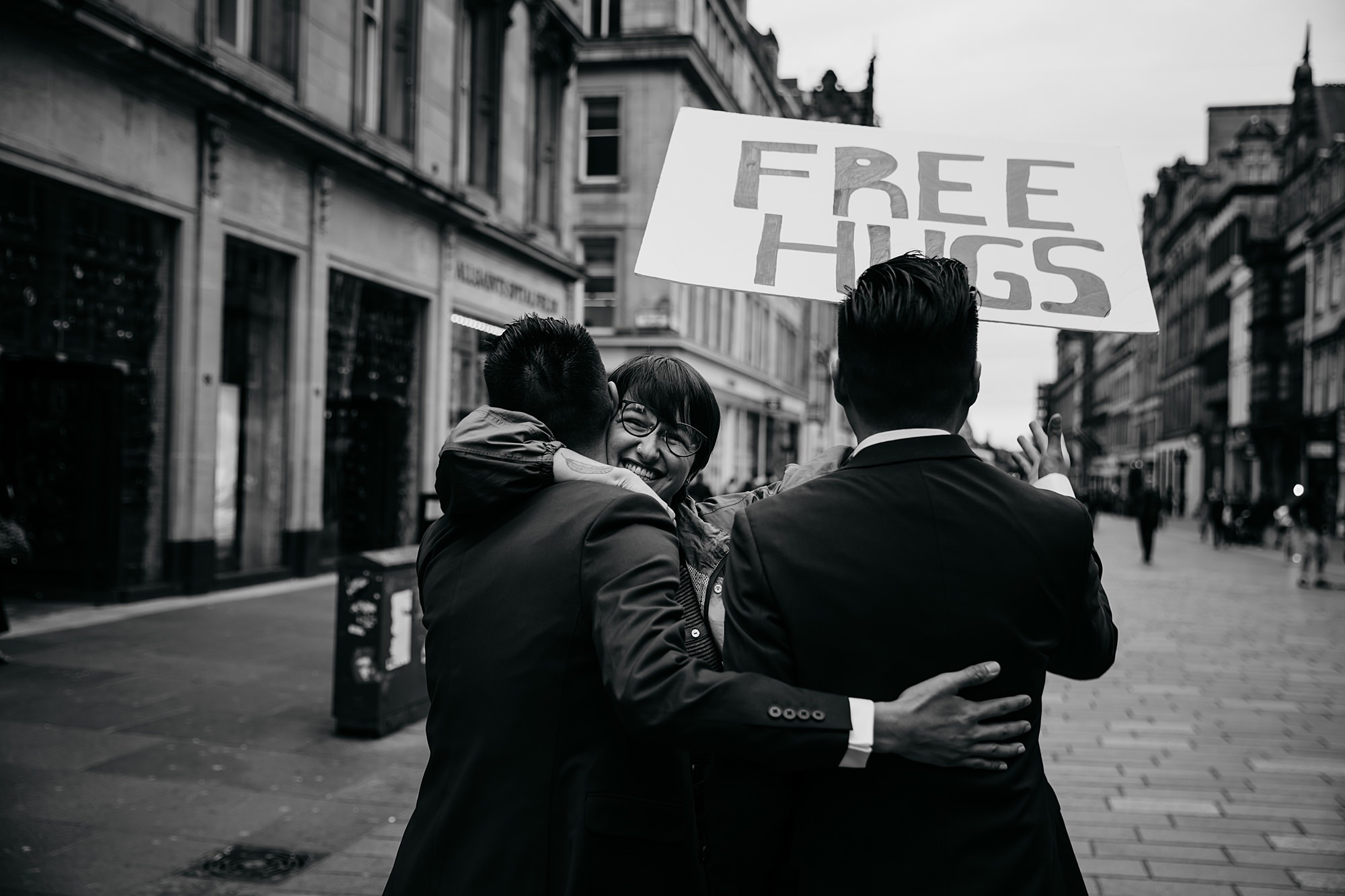 Free hugs for two grooms during their Glasgow elopement.