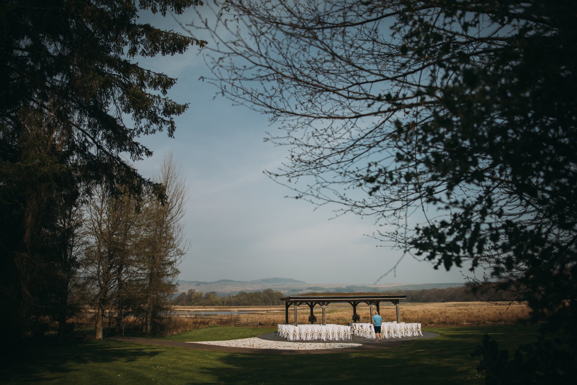 Groom checks over the outdoor ceremony setup at his High Wards wedding.