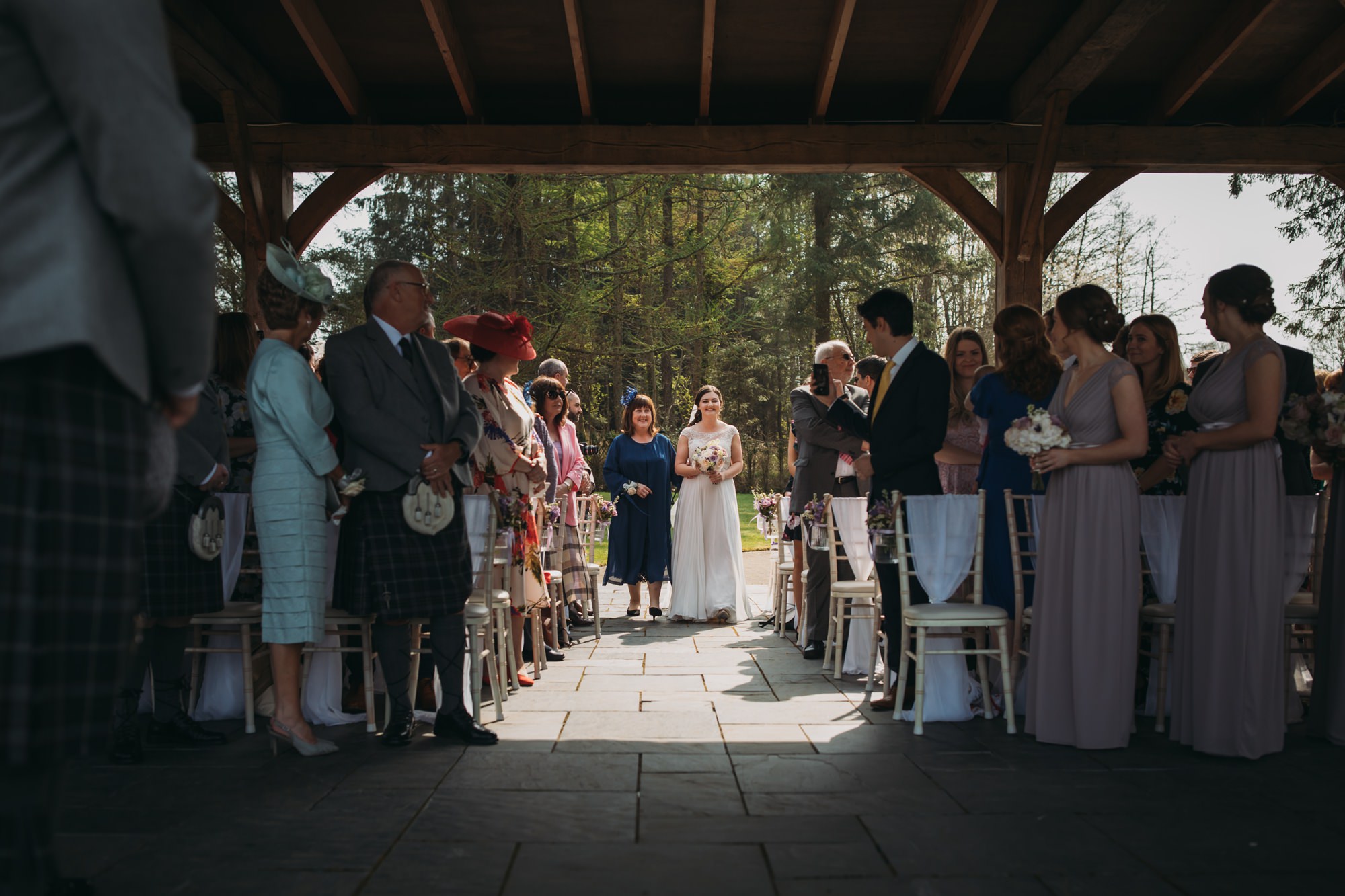 Bride walks down the aisle with her Mum at her High Wards wedding