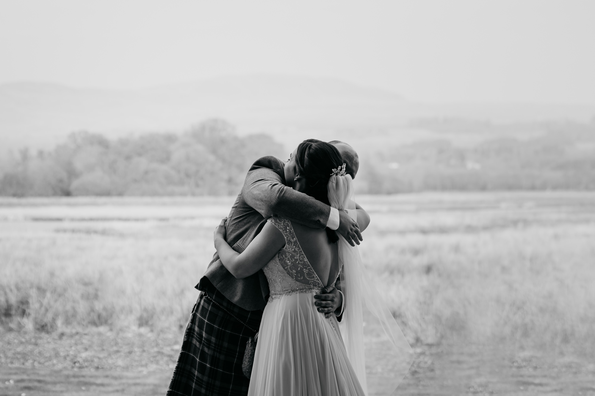 Bride and Groom start of their High Wards wedding ceremony with a Mexican Hug