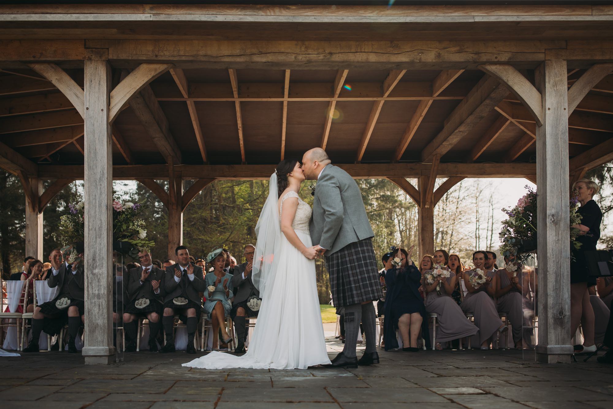 First kiss at a High Wards wedding outdoor ceremony