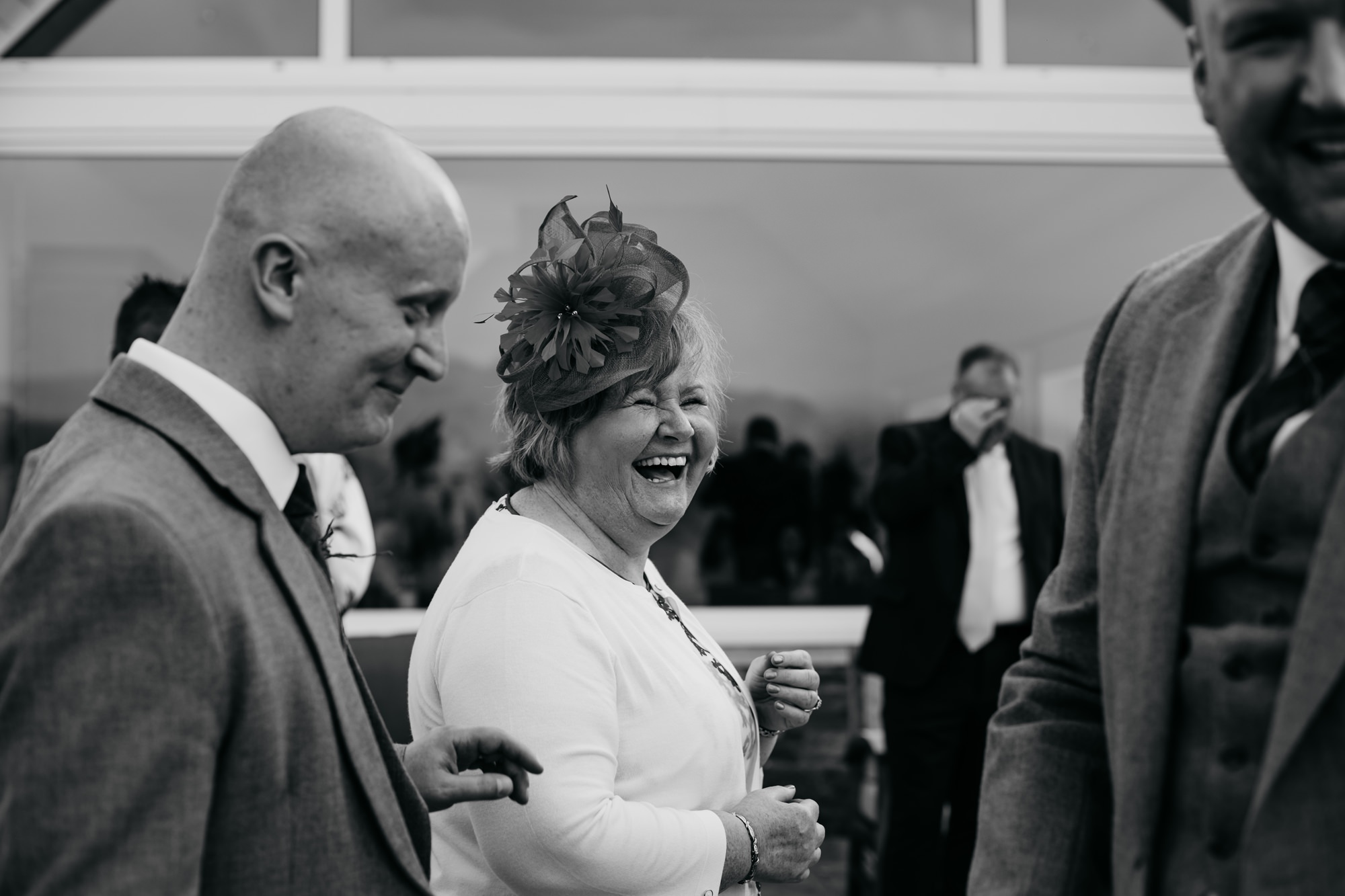 Guest laughs with Groom at a High Wards wedding reception