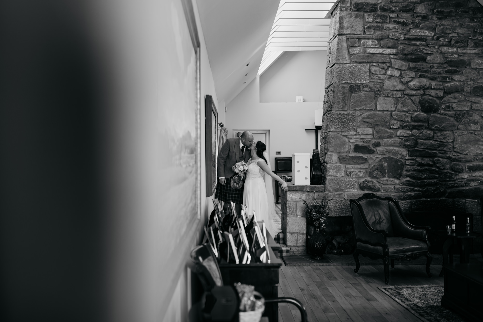 Newlyweds kiss before being announced for dinner at their High Wards wedding