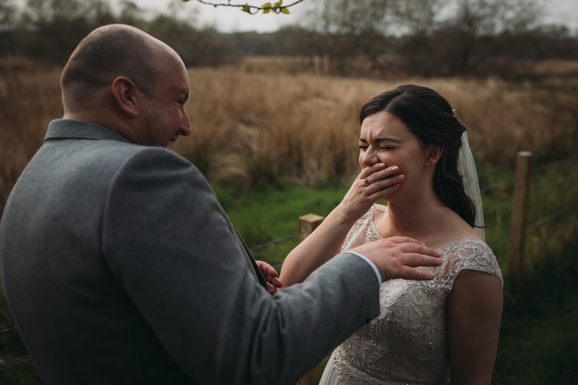 Newlyweds laugh together during their High Wards wedding