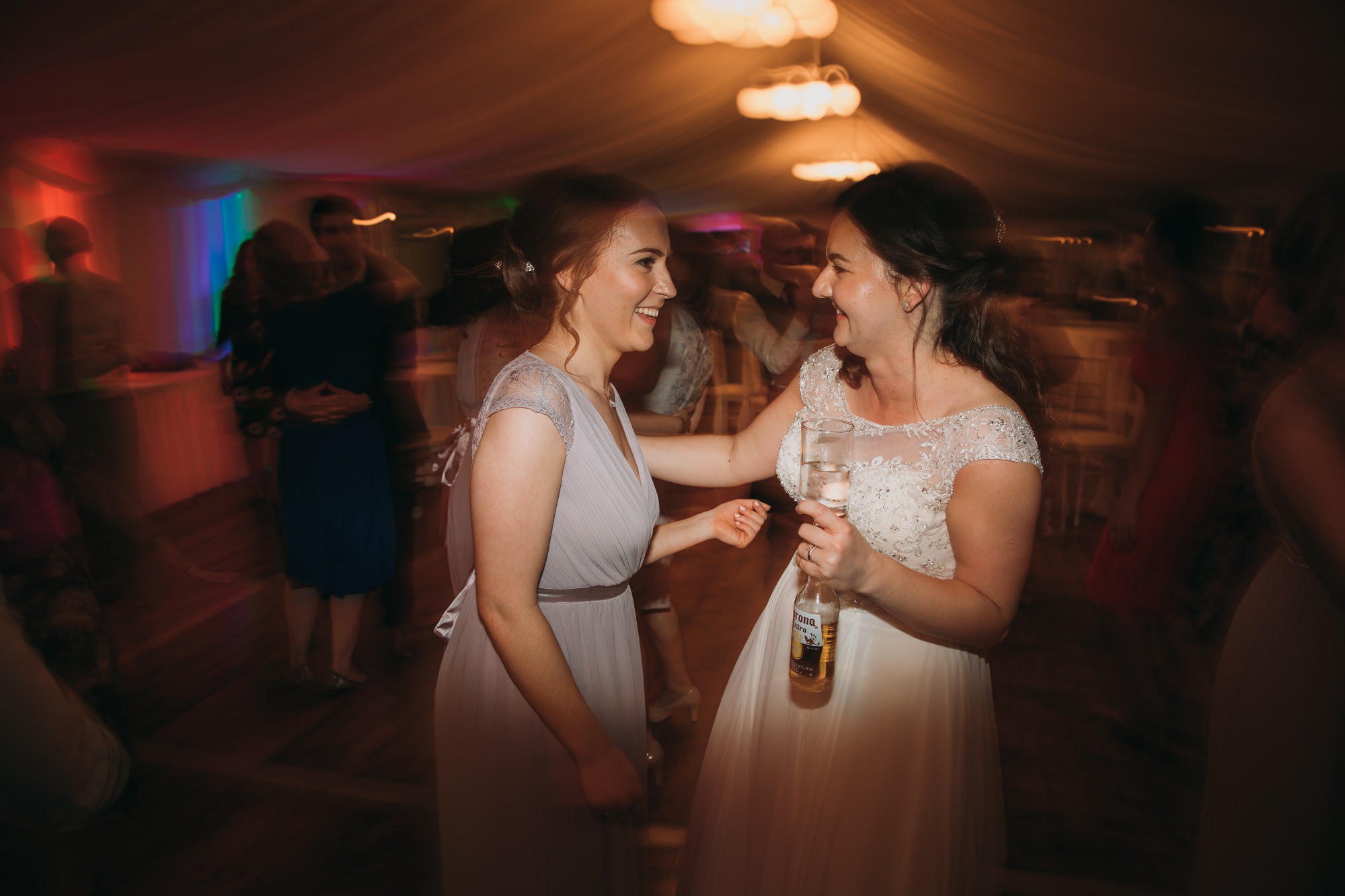 Bride and best friend share a moment at a High Wards wedding