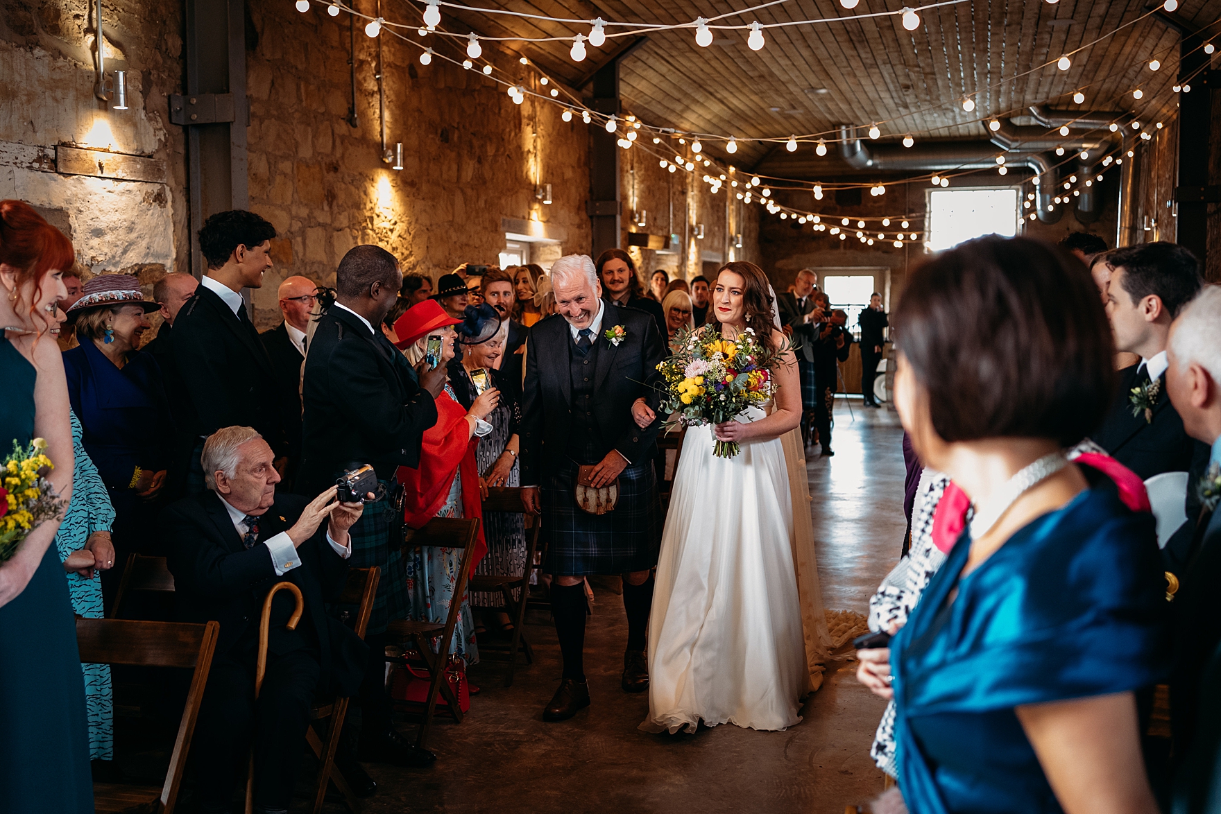 spring wedding falside mill indoor ceremony reception space bride festoon lights