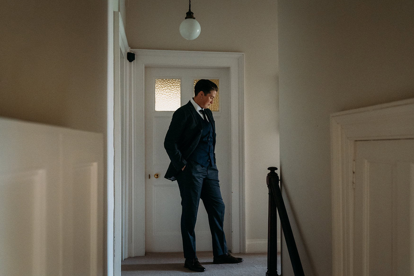 woman stands in suit at Brodie Castle