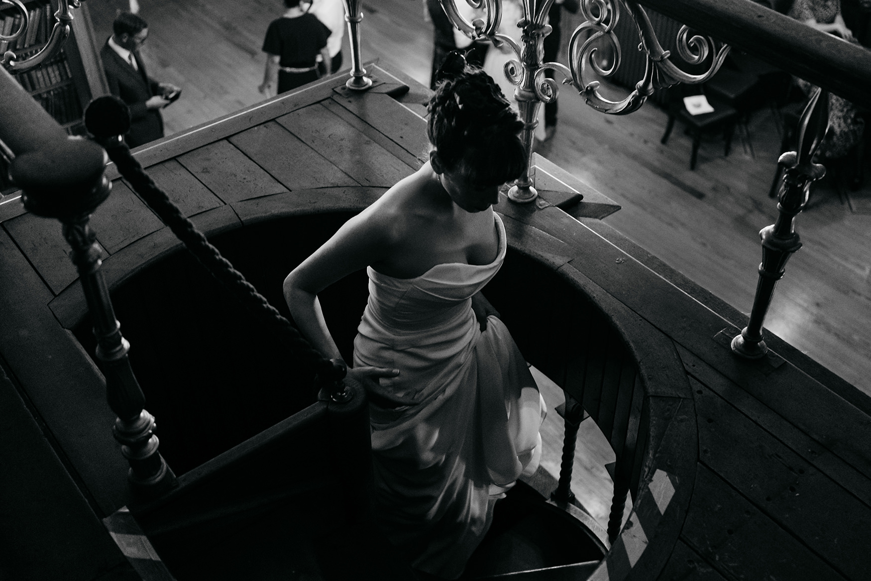 bride walks up spiral staircase at Royal College of Physicians Wedding