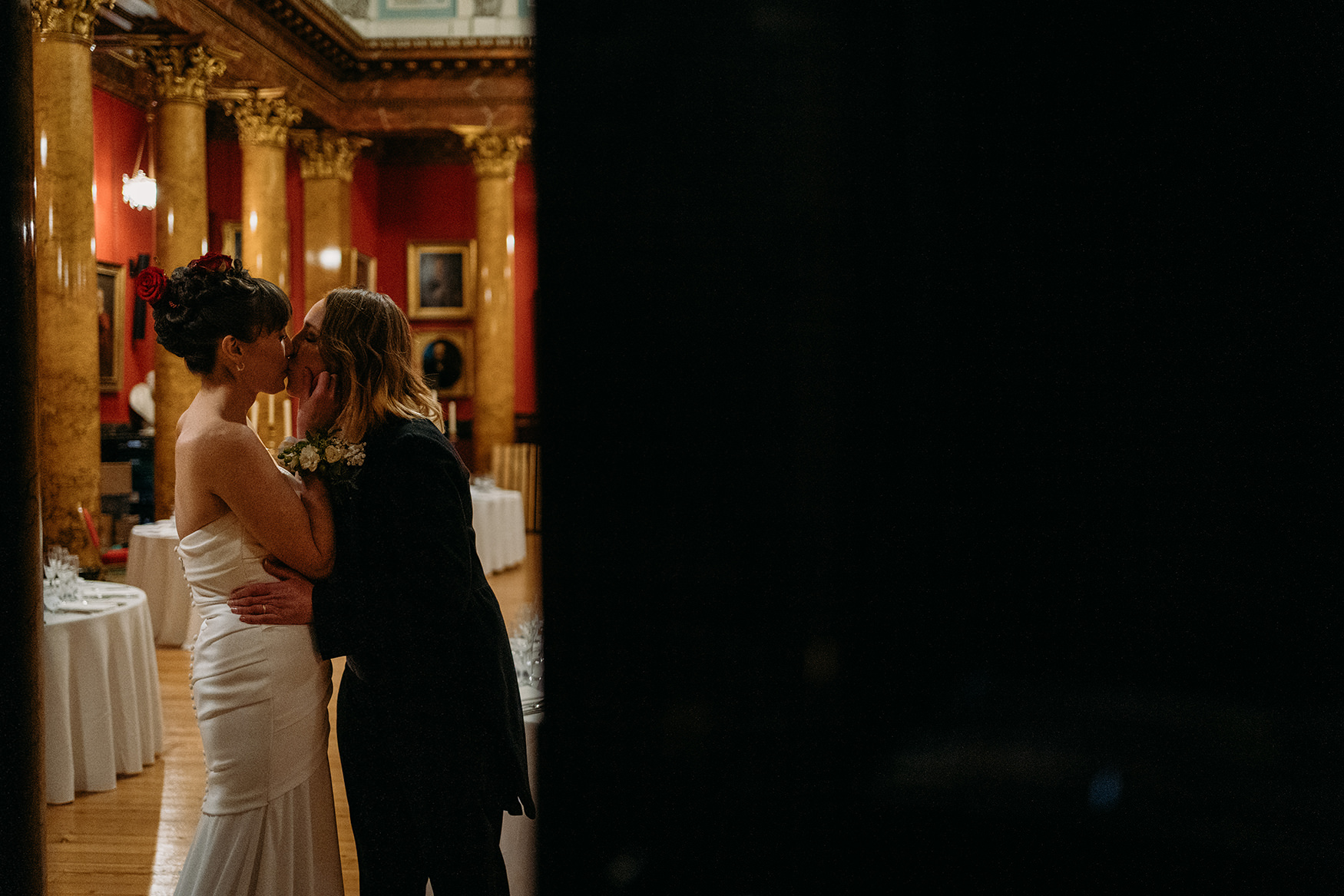two brides share a secret kiss after their Royal College of Physicians Wedding ceremony