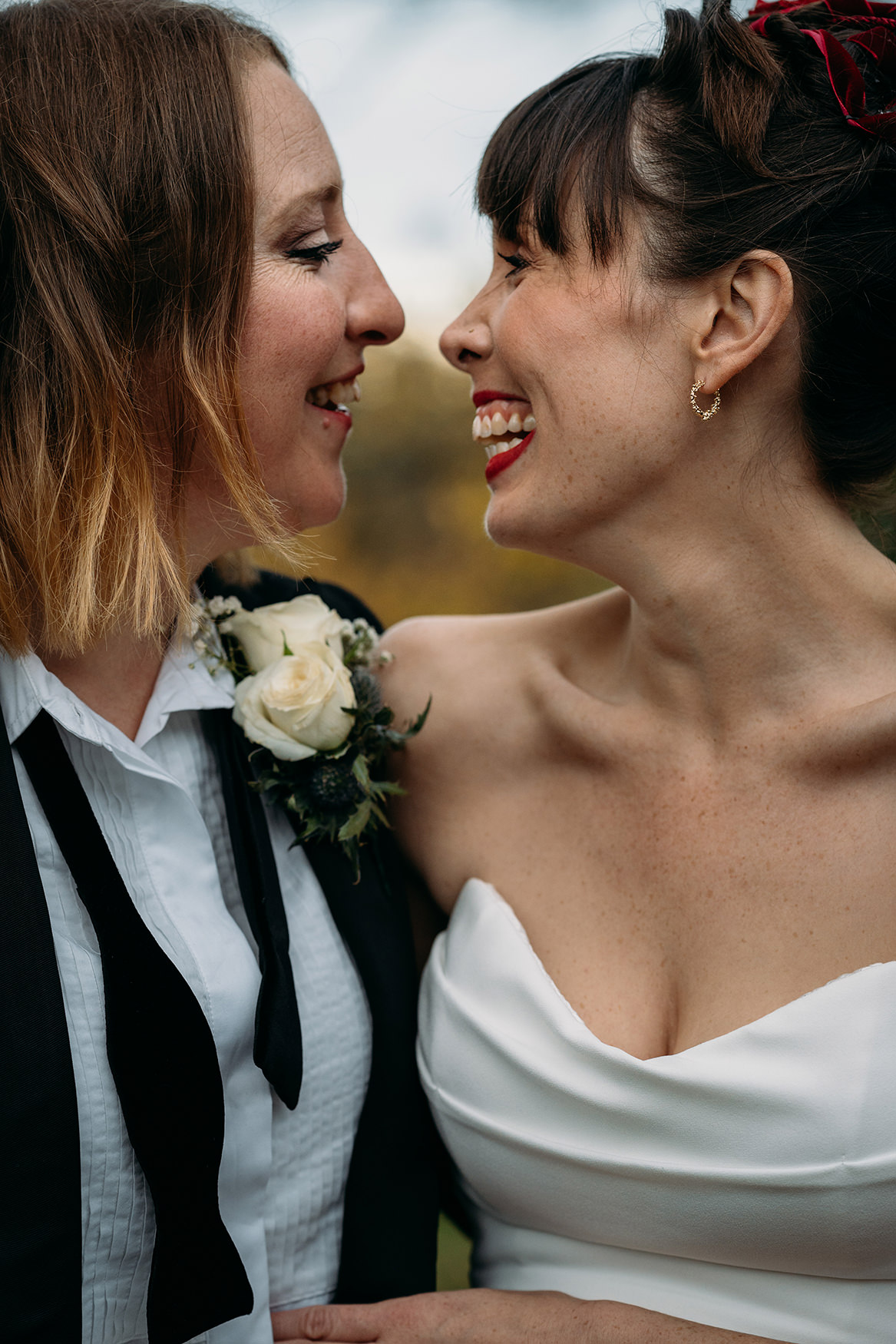 portriat of two brides happily looking at each other at their Royal College of Physicians Wedding