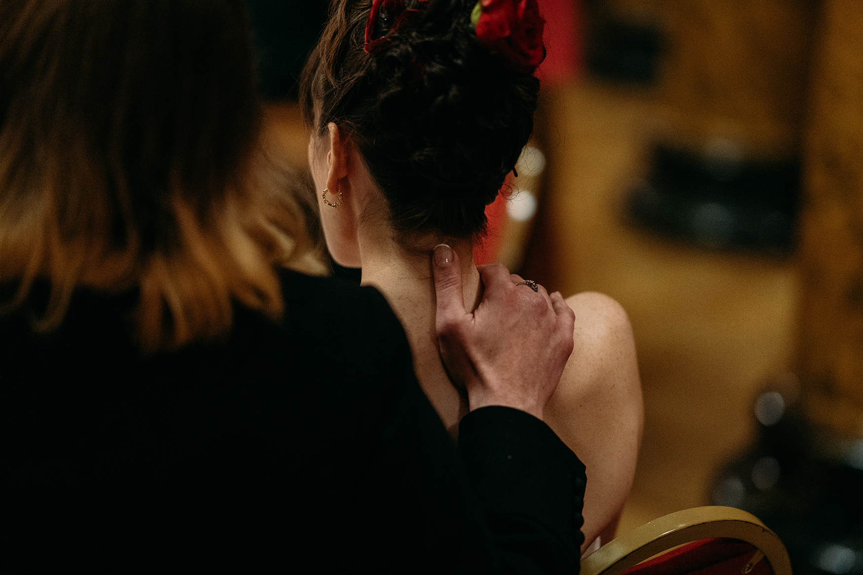 Bride gently touches her wife's neck during Royal College of Physicians Wedding